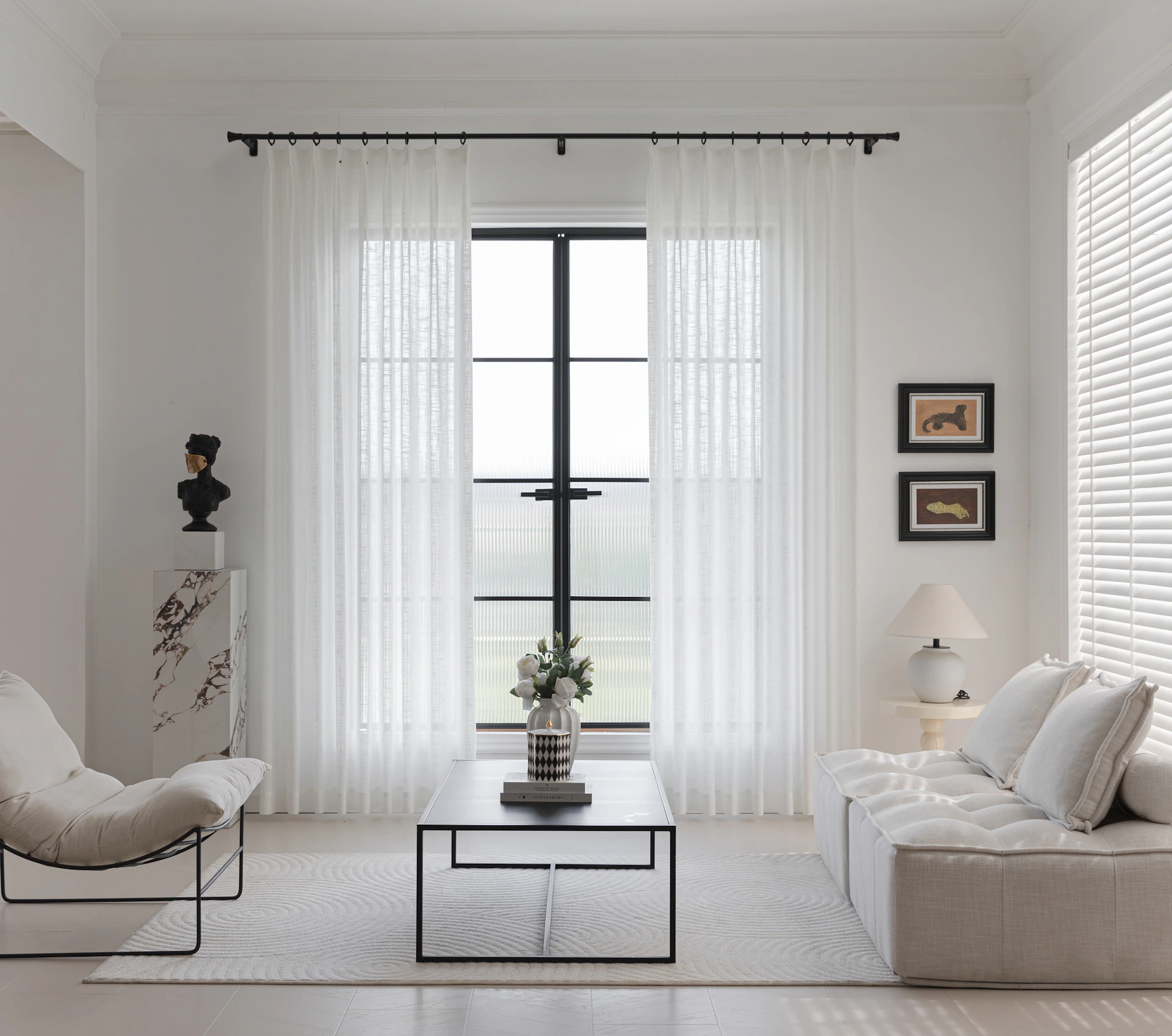 A bright, minimalistic living room with white decor.