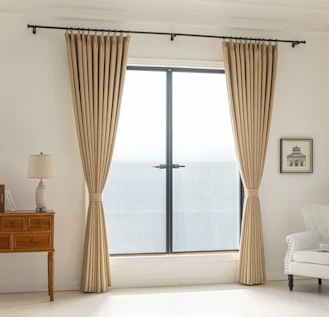 Elegant curtains frame a window in a bright room.