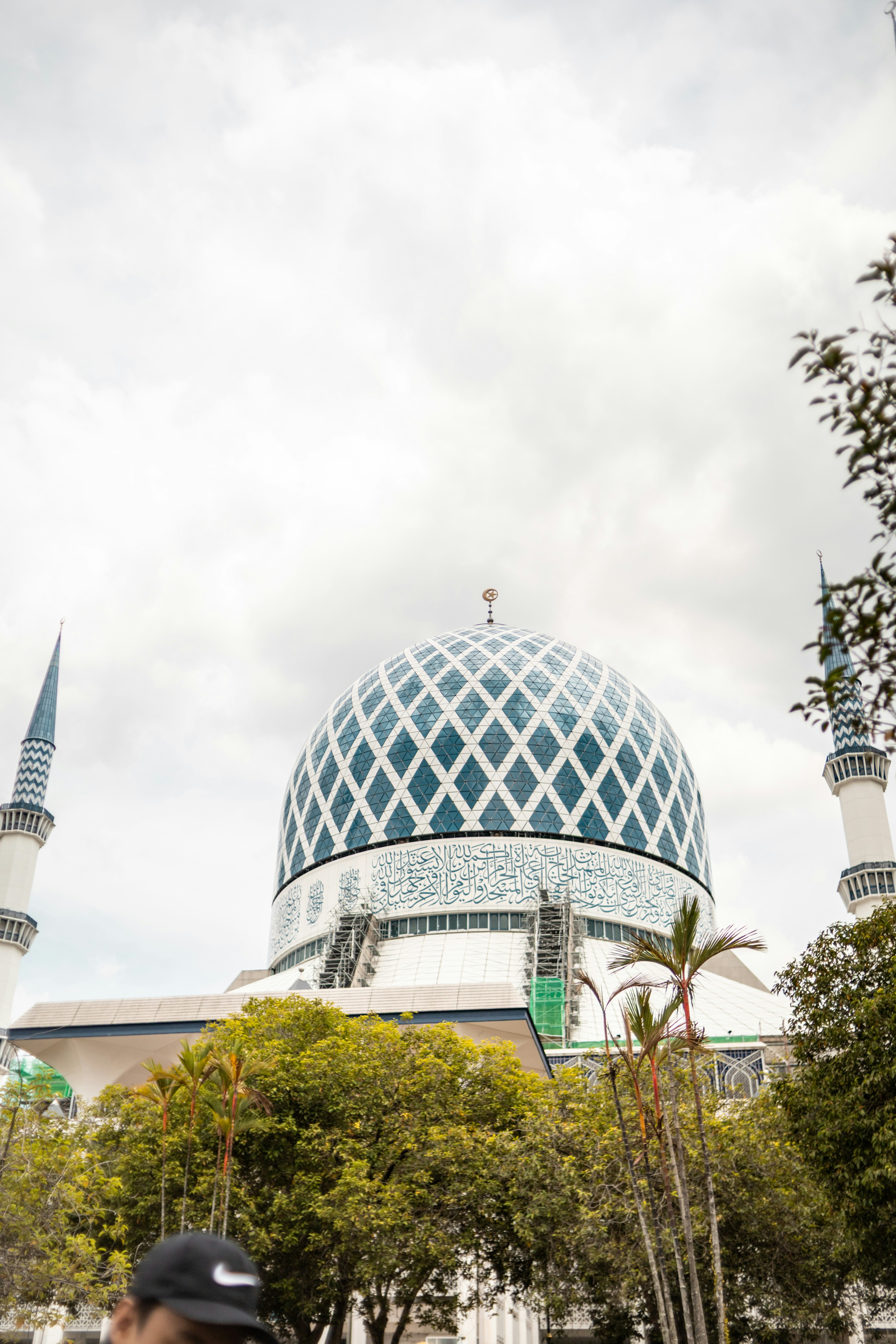 A mosque with a beautiful blue dome is shown.