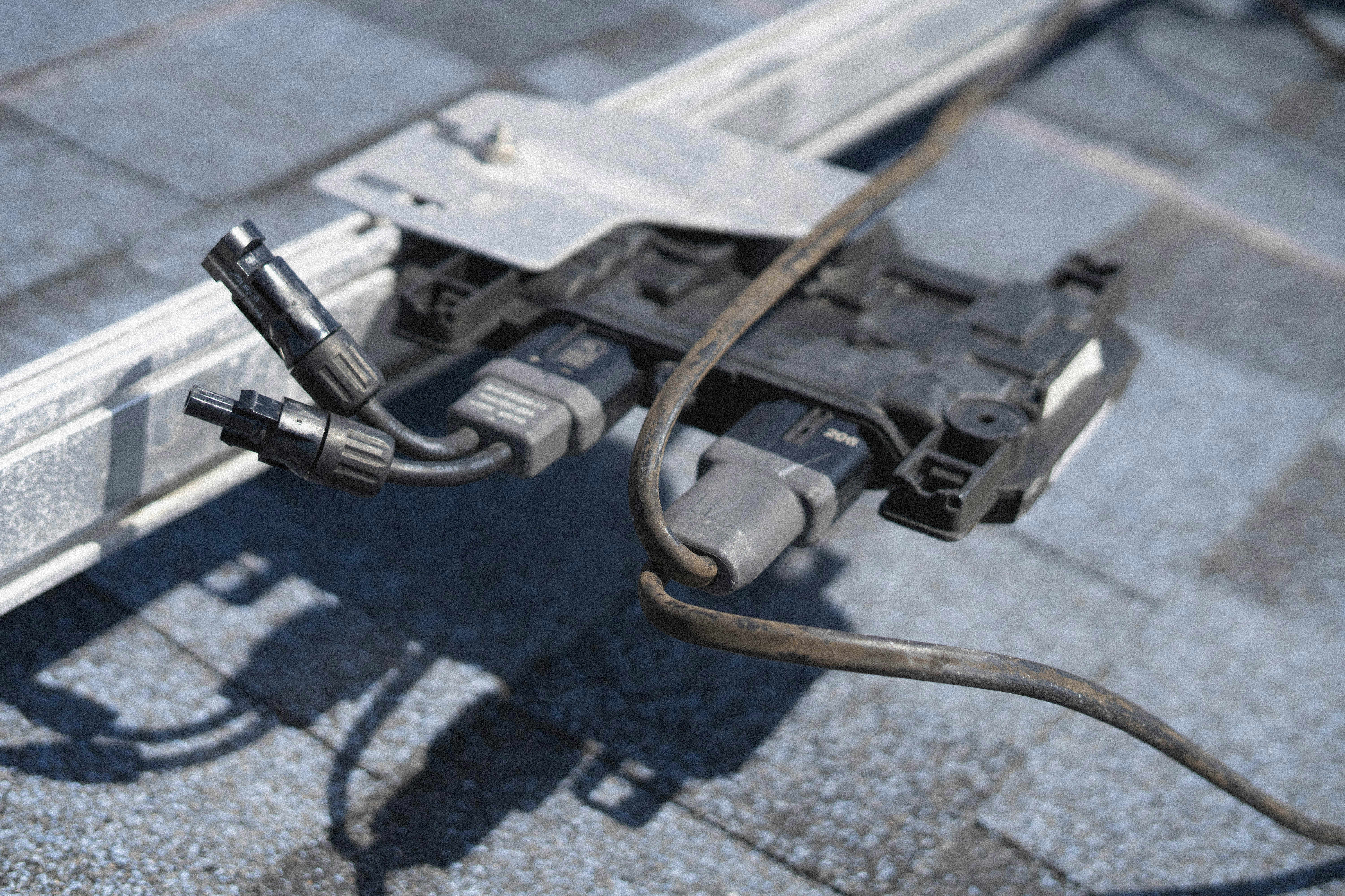 Solar panel connectors and wiring on a roof.