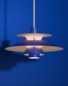 A modern blue pendant lamp illuminates the room.