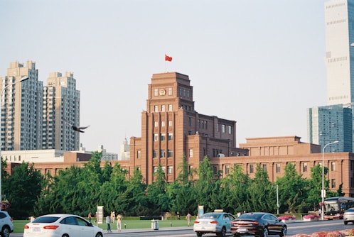 Brick building with a chinese flag on top.