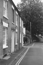 Terraced brick houses line a quiet street