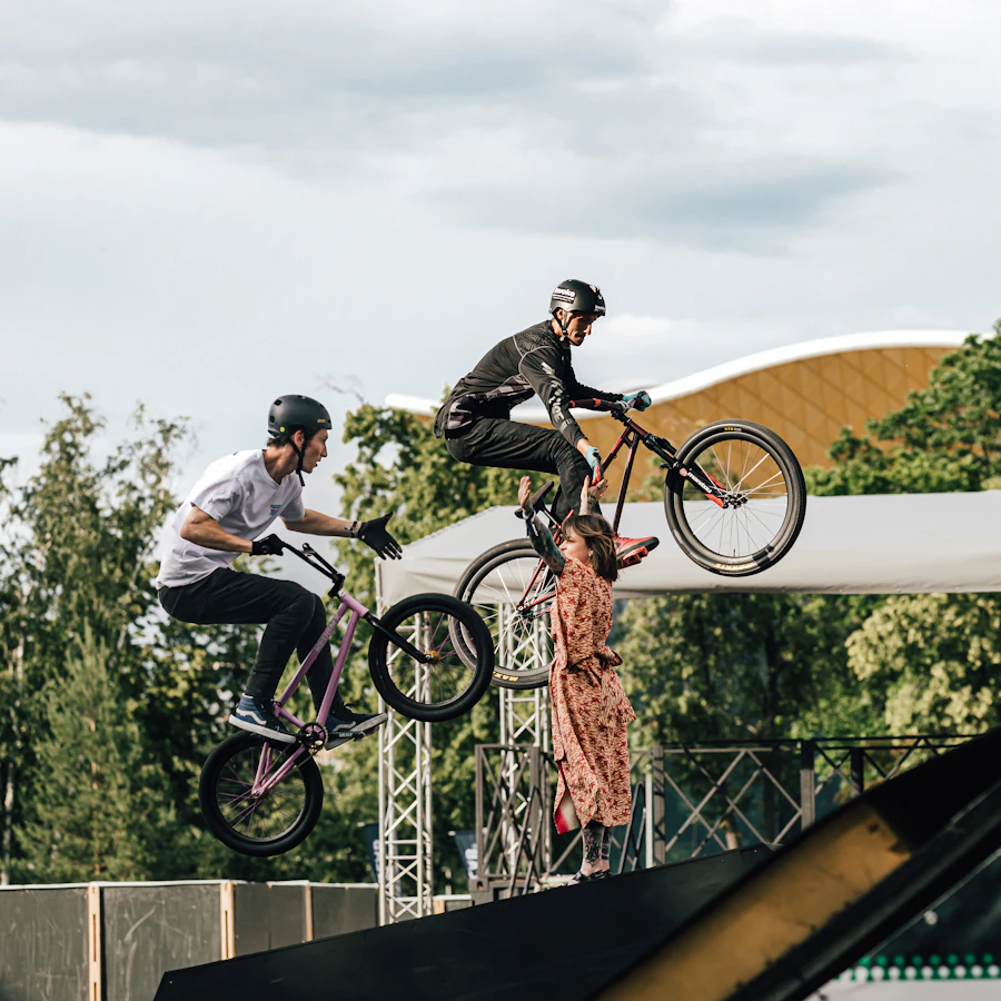 BMX riders performing stunts on a ramp