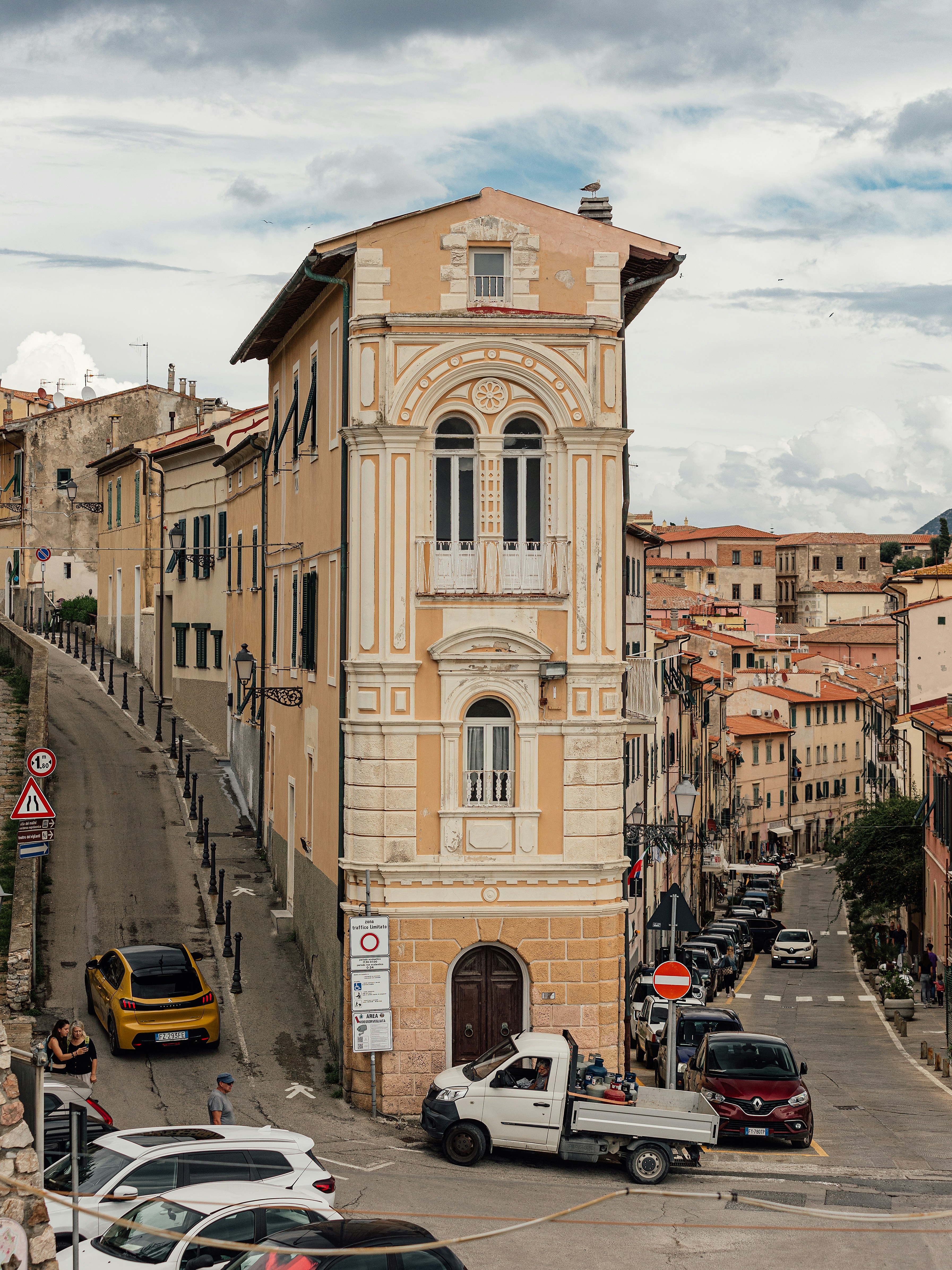 Narrow street with historic buildings and parked cars photo – Free ...