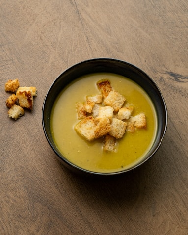 Bowl of creamy soup topped with croutons