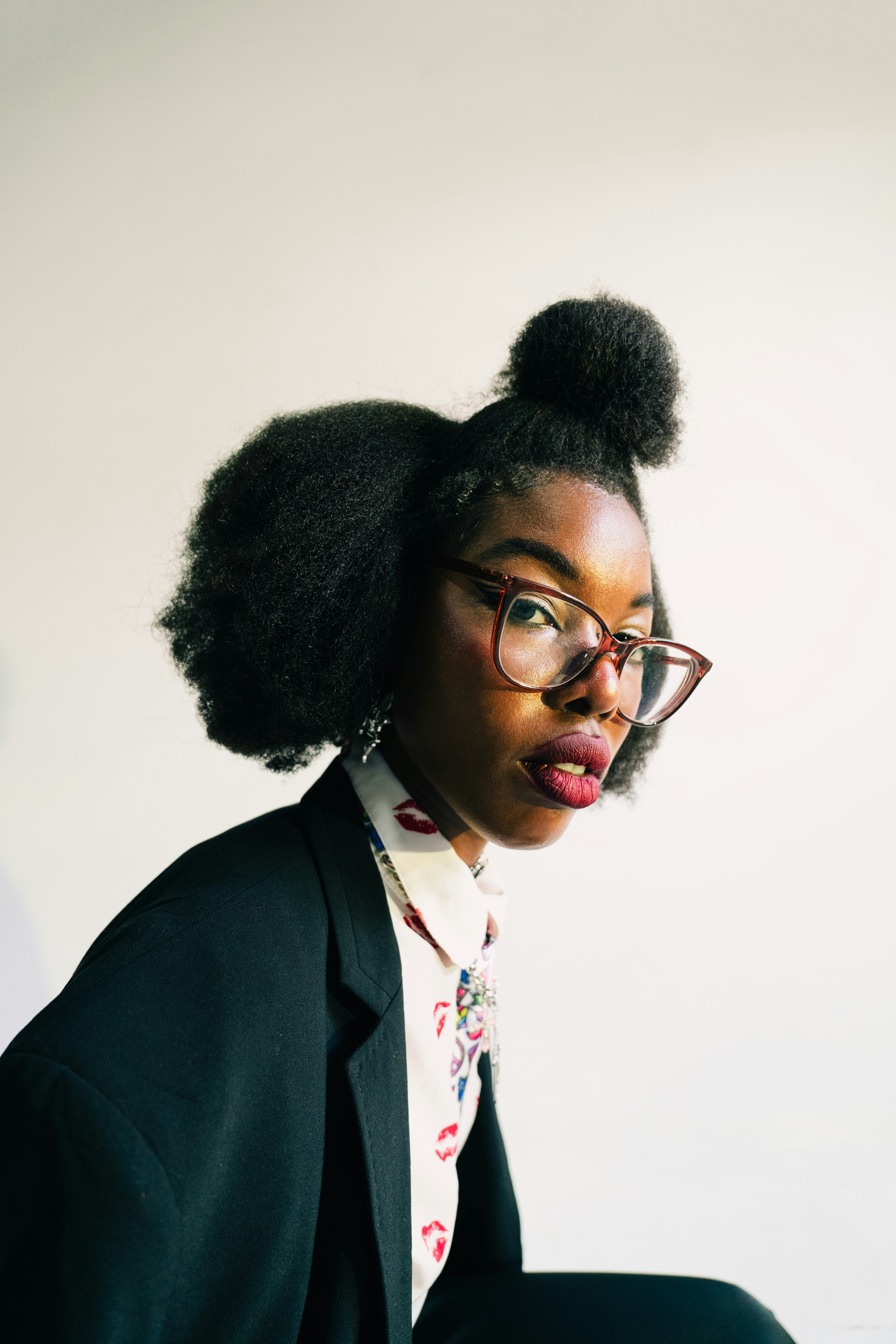 Woman with glasses and styled hair wearing a blazer