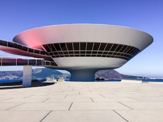 Modern circular building with glass windows and walkway