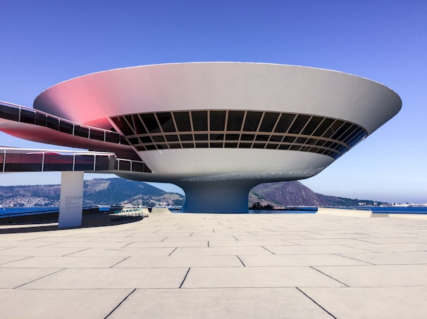 Modern circular building with glass windows and walkway