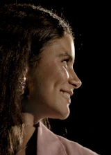 Profile of a smiling young woman with dark hair