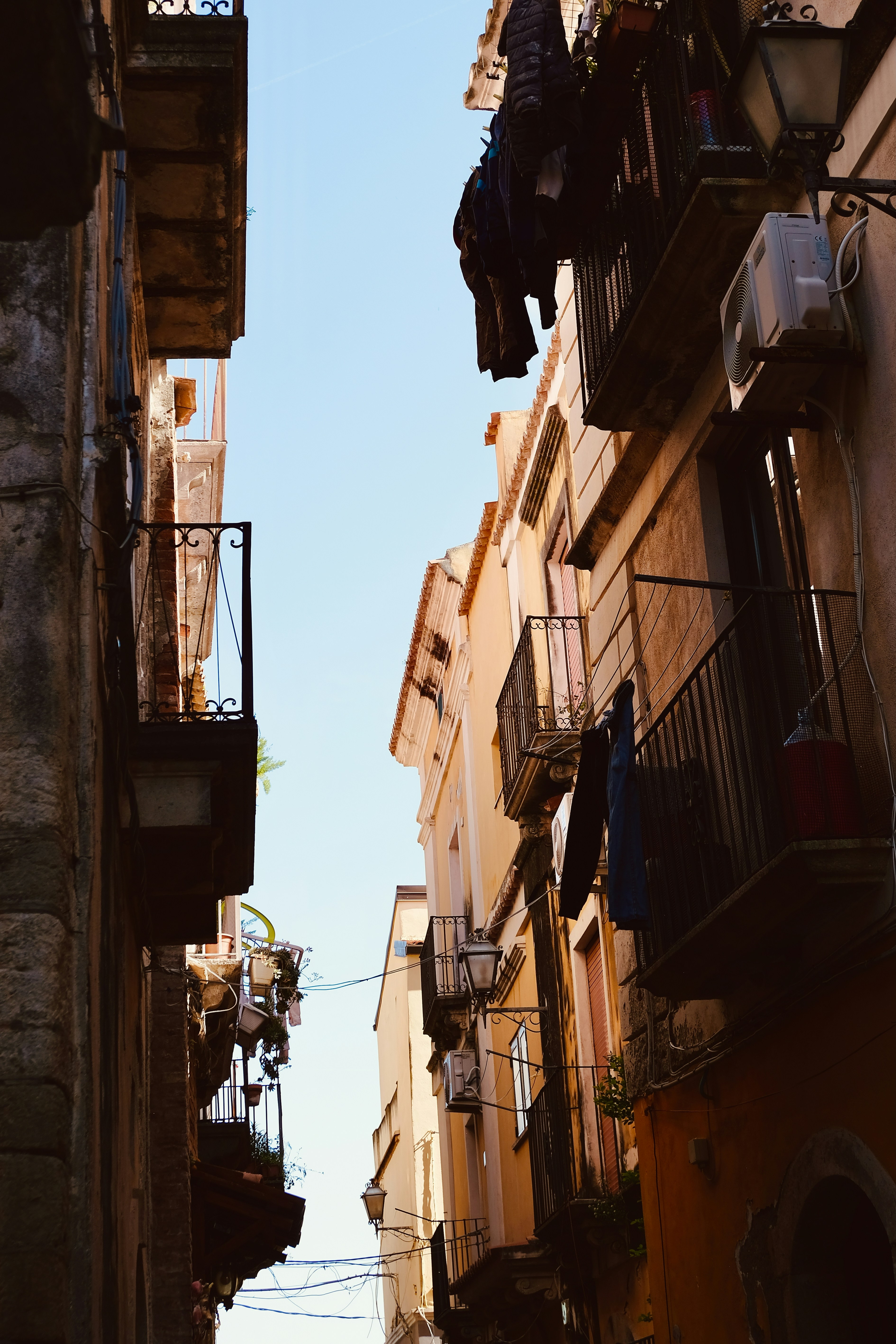 Narrow street with buildings and laundry hanging