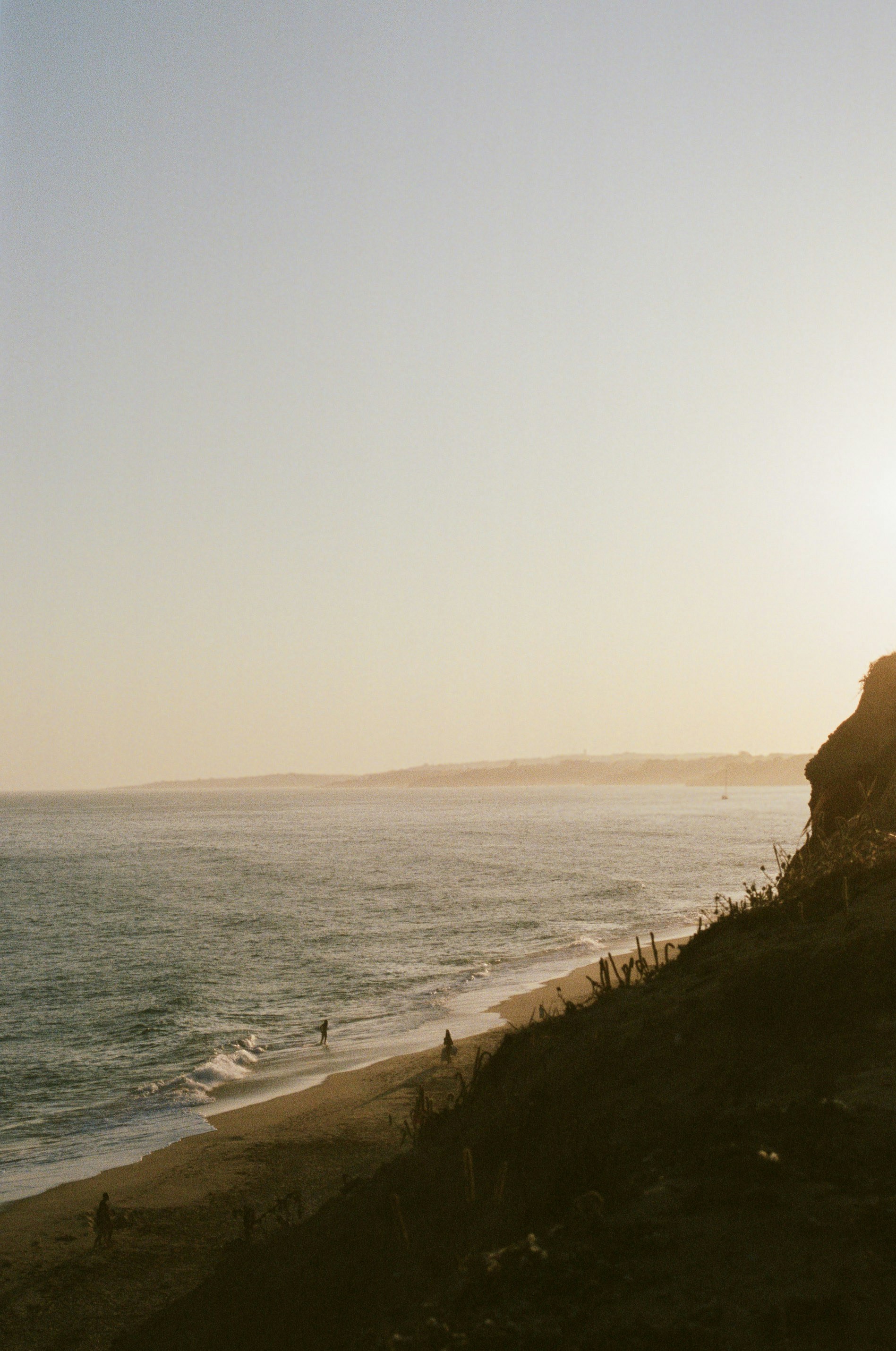 Golden sunset over a calm ocean and coastline