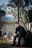 Man in black turtleneck sitting outdoors near tree