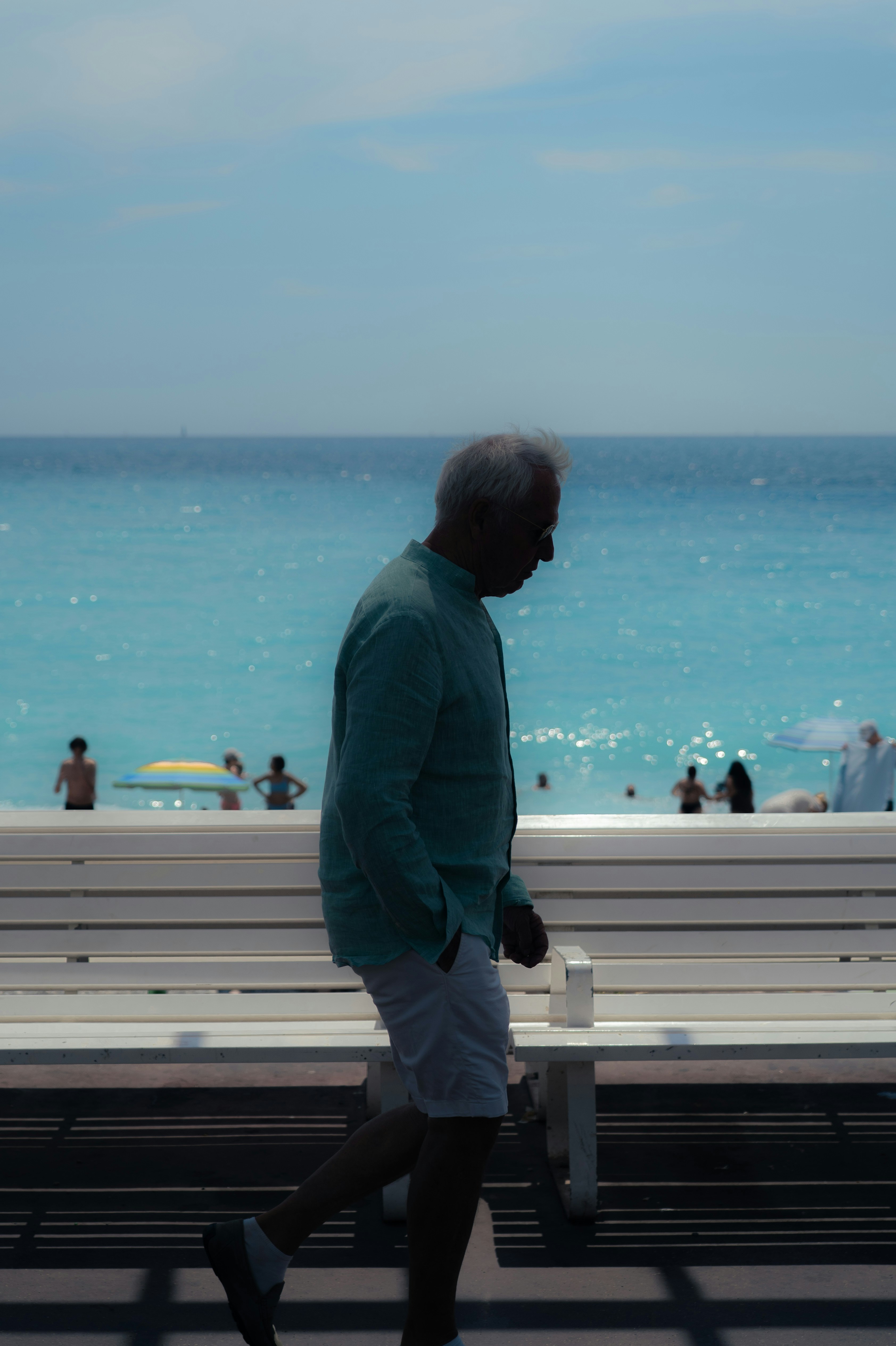 Man walking on boardwalk next to ocean