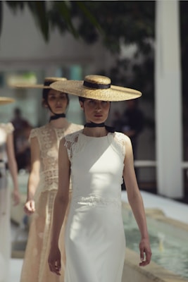 Women in elegant dresses and wide-brimmed hats