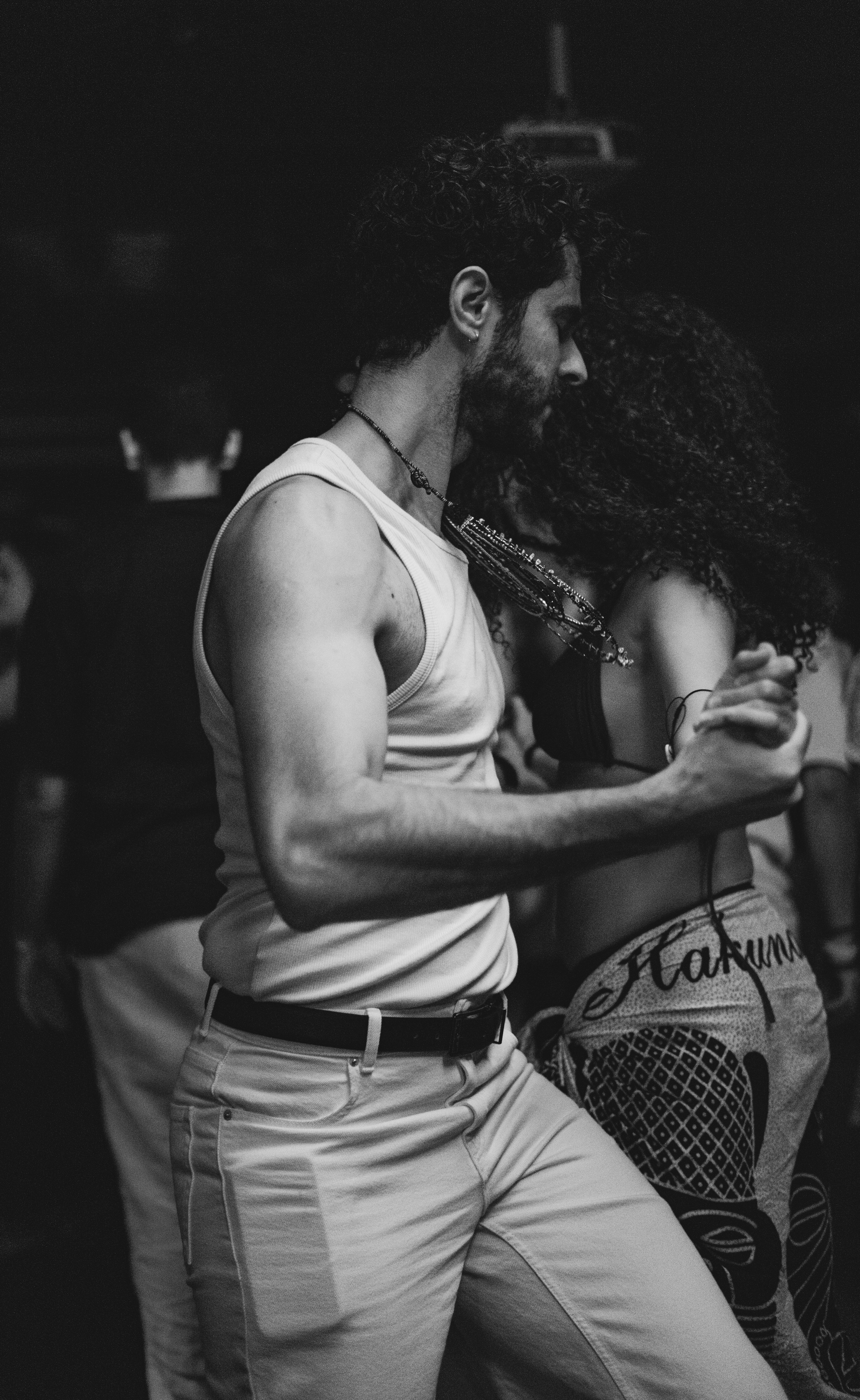 Couple dancing together in a dimly lit room.