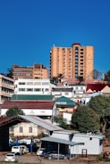 Buildings on a hillside under a clear blue sky.