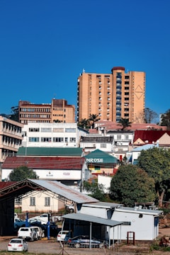 Buildings on a hillside under a clear blue sky.
