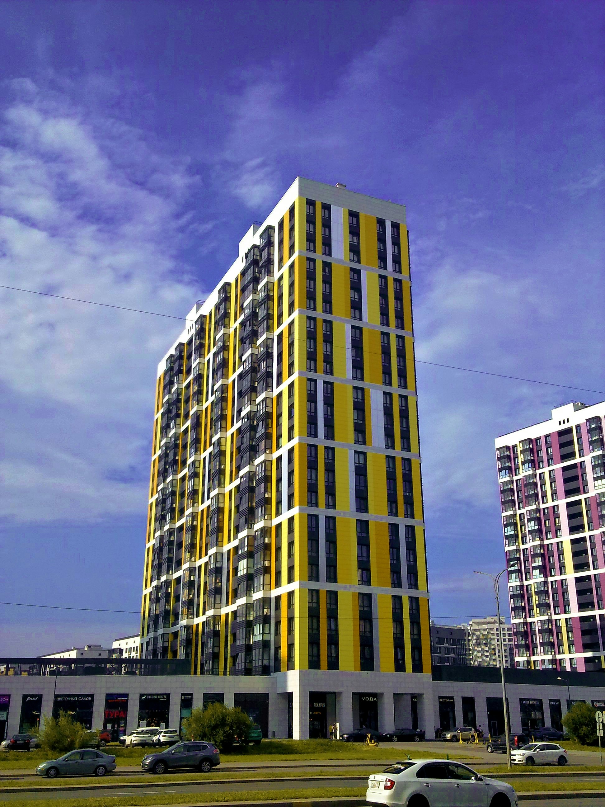 Modern yellow building against a blue sky
