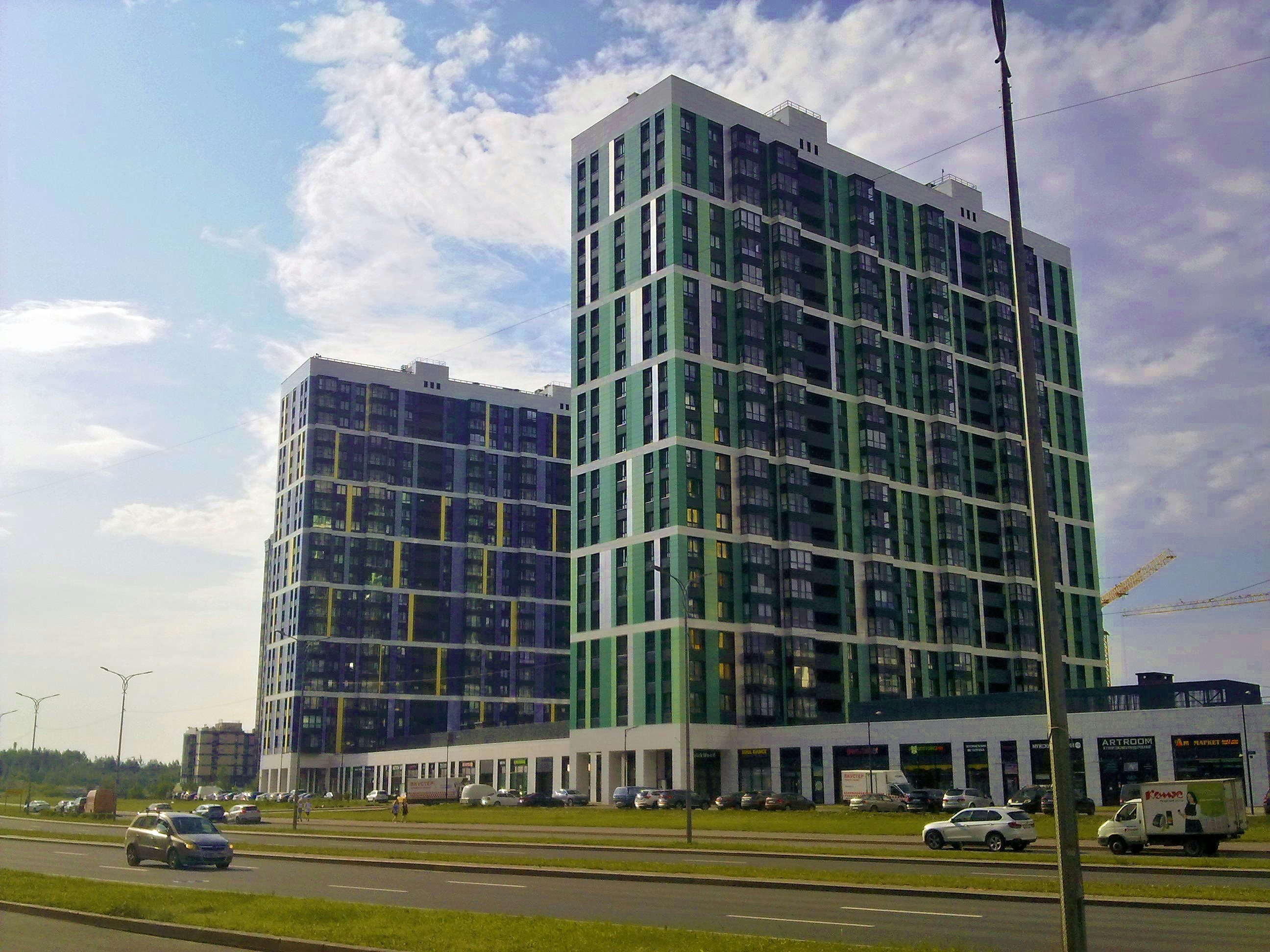 Modern buildings with glass facades under a cloudy sky