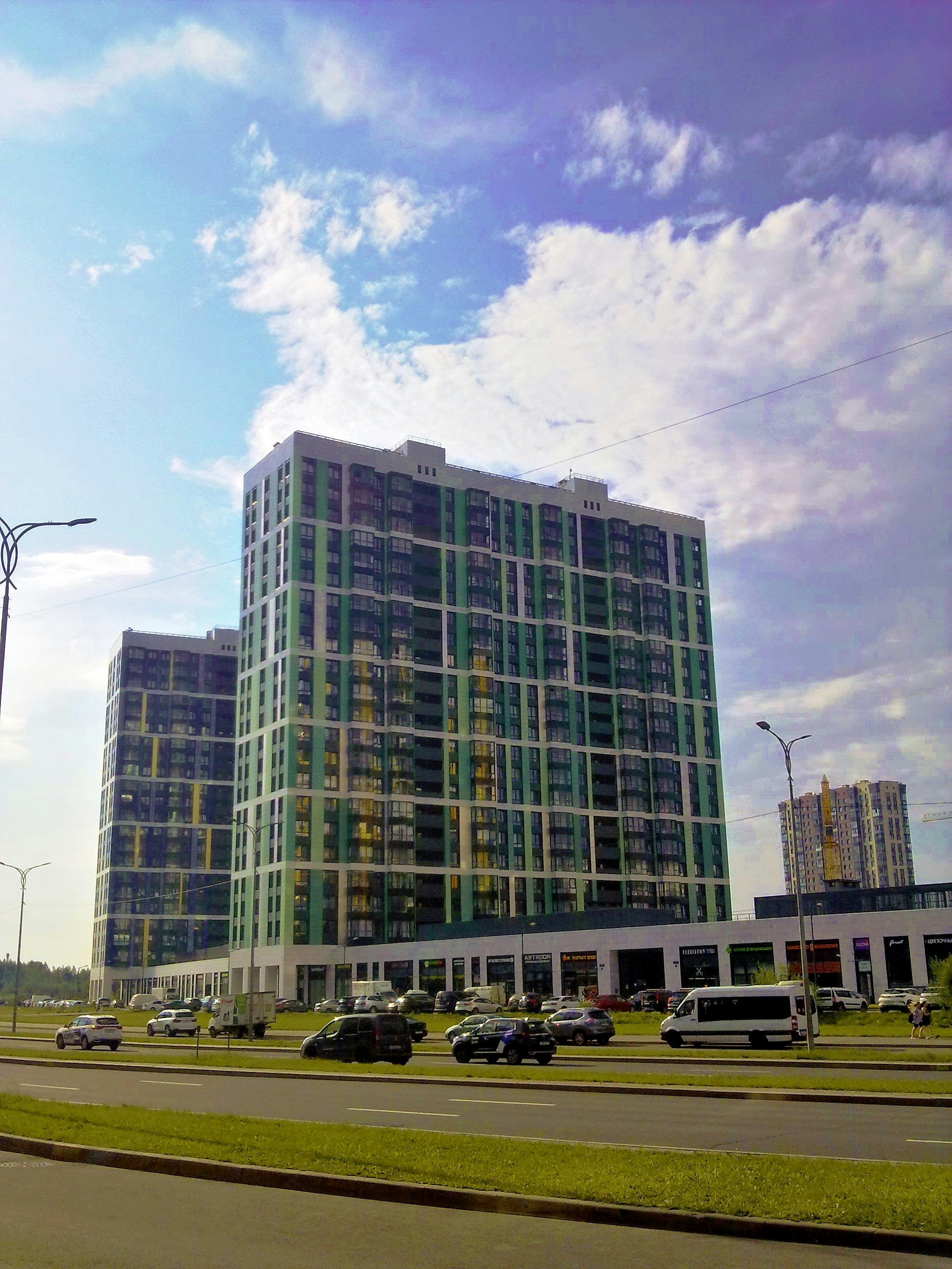 Modern glass buildings under a cloudy sky