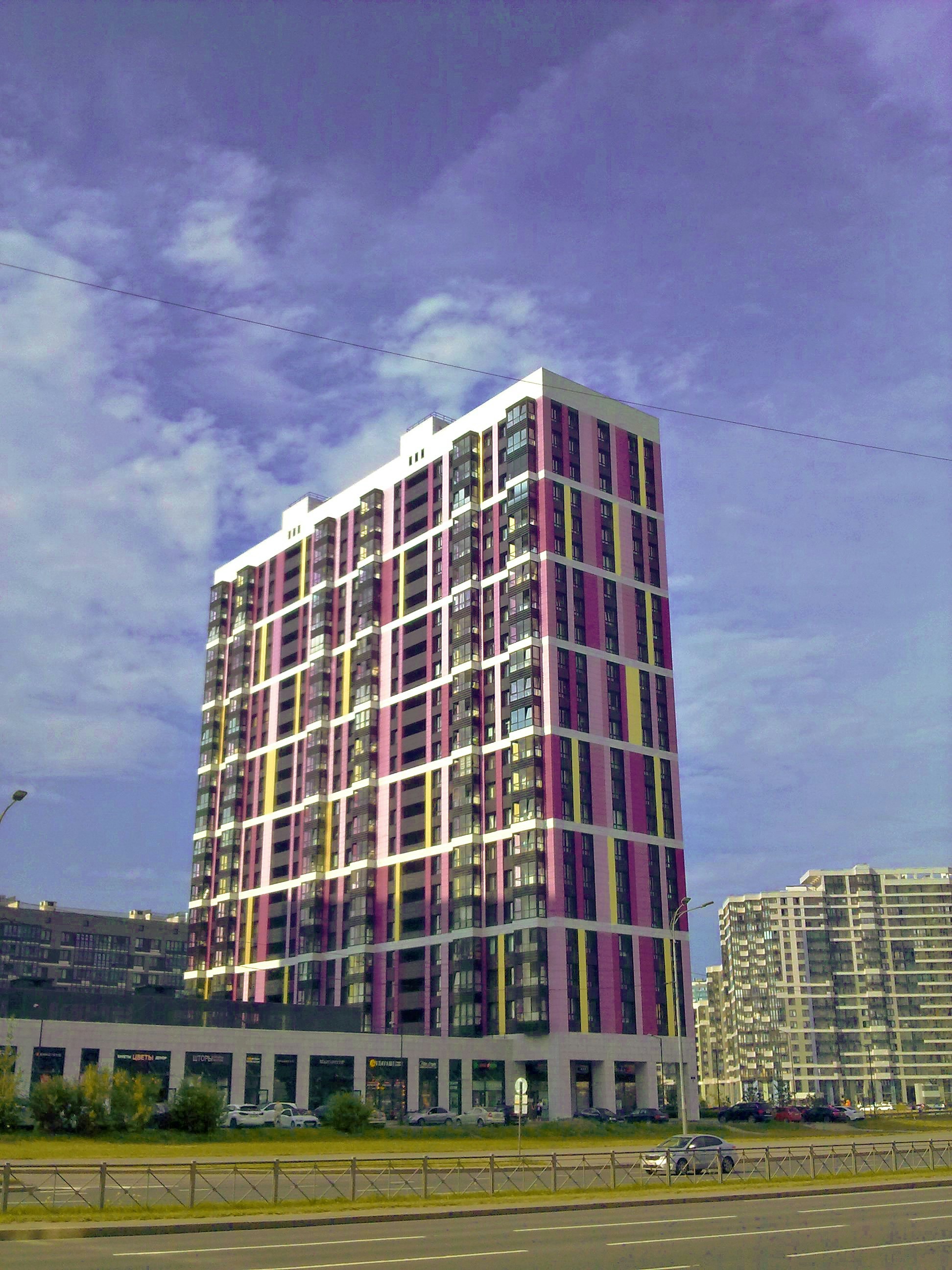 Modern building with colorful windows against blue sky