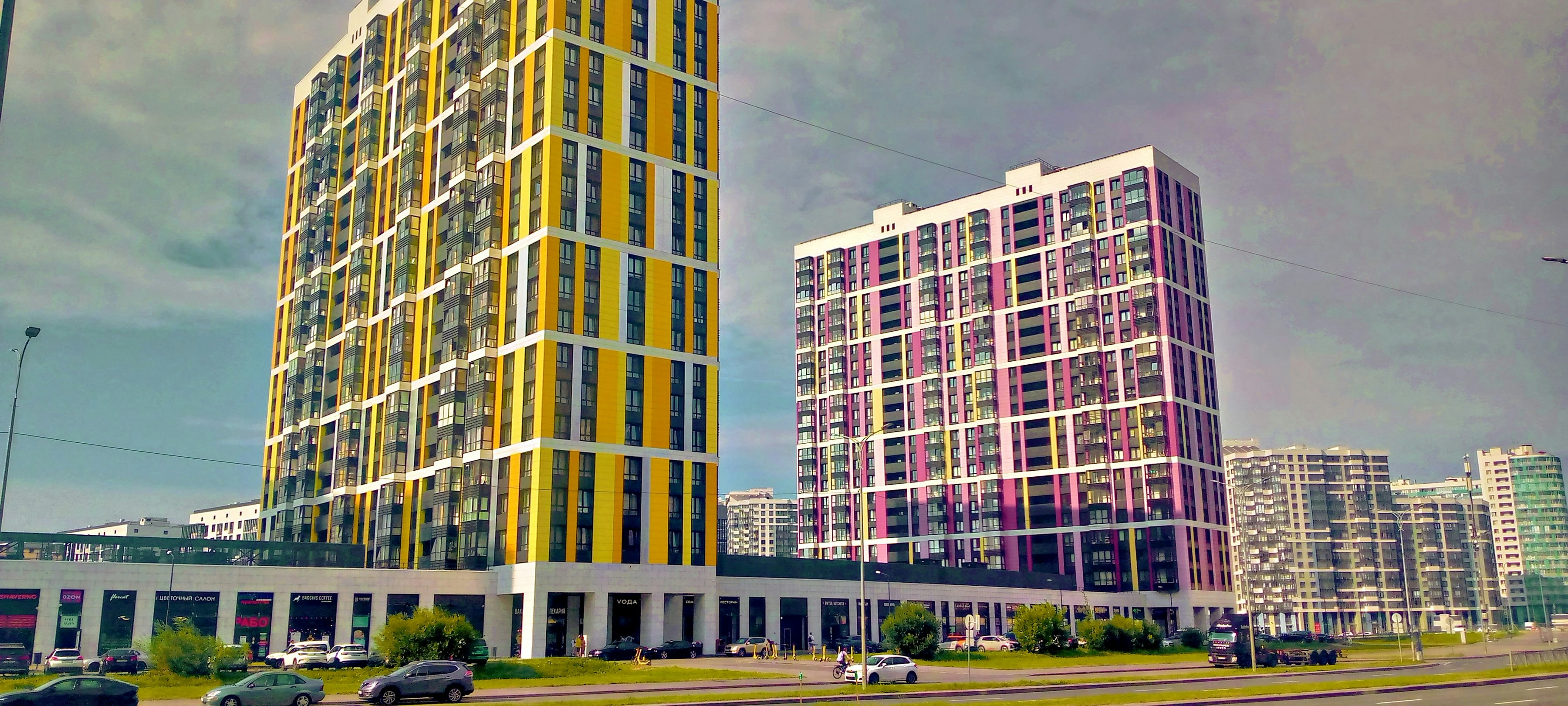 Two modern buildings against a cloudy sky