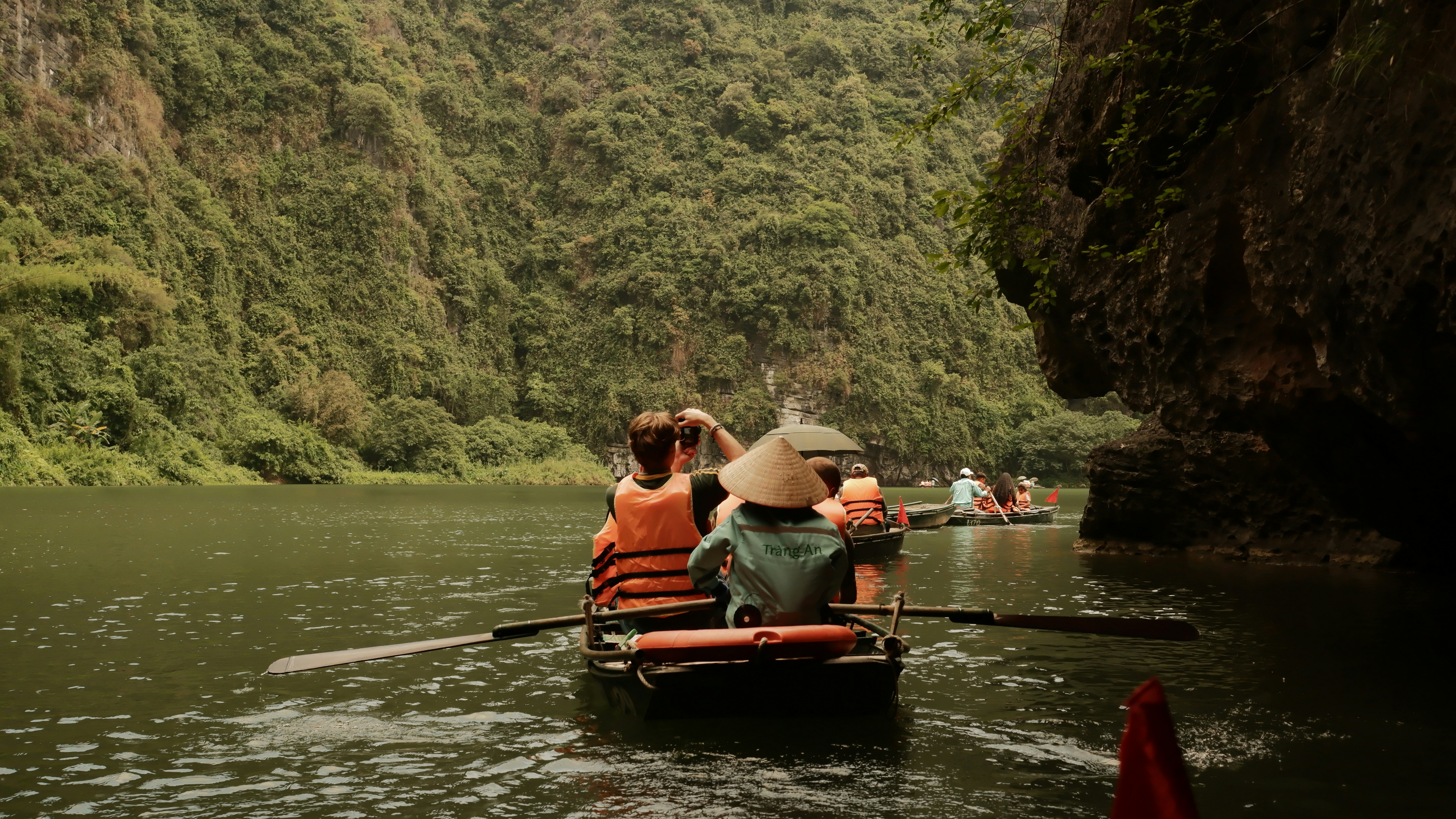 People on a boat sailing through a river