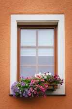 Window with colorful flowers in a planter