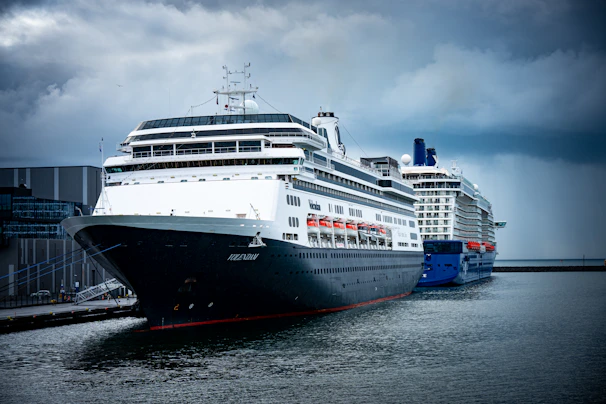 Large ferry docked at a harbor under cloudy sky