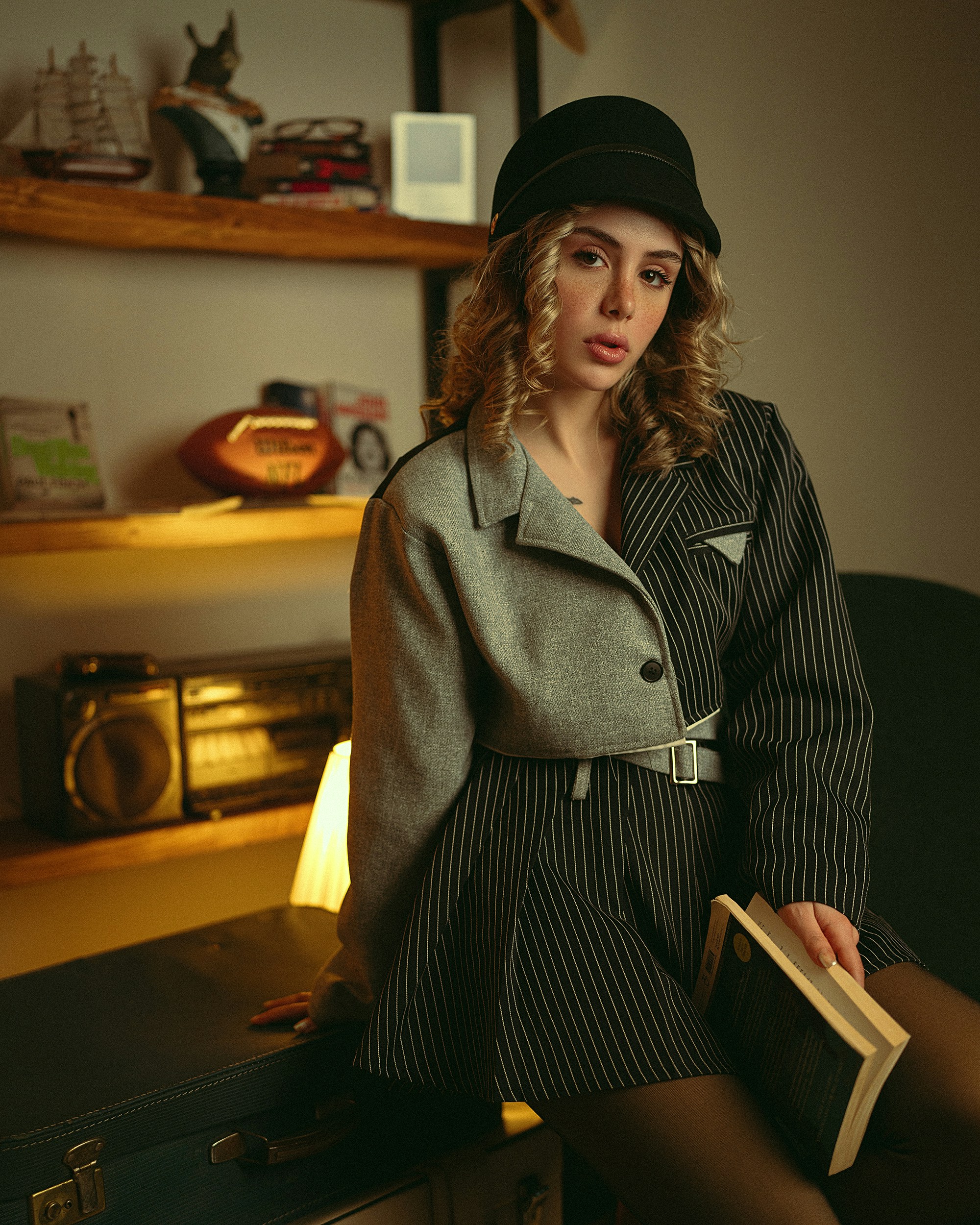 Woman in stylish outfit holding a book