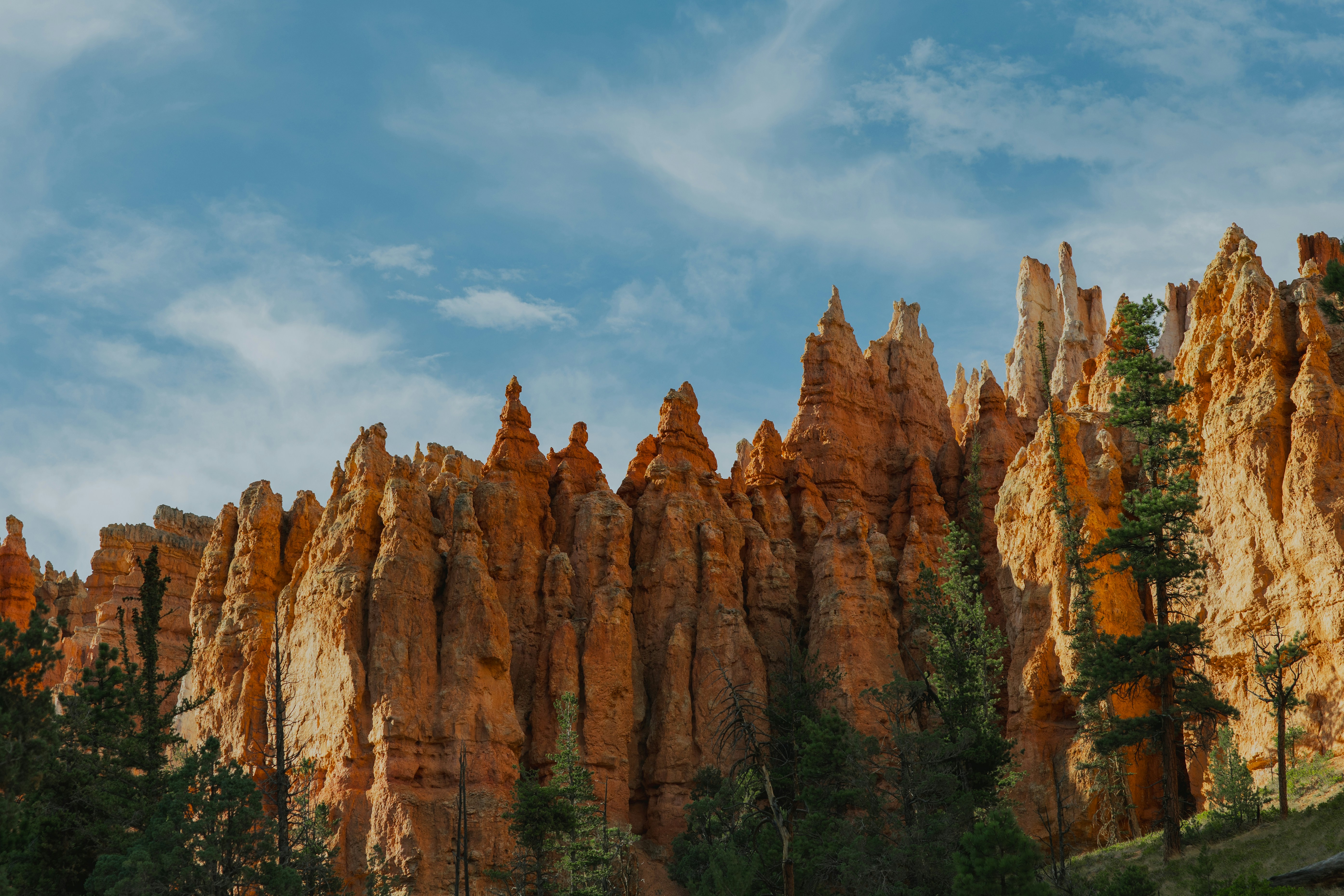 Tall sandstone hoodoos against a blue sky