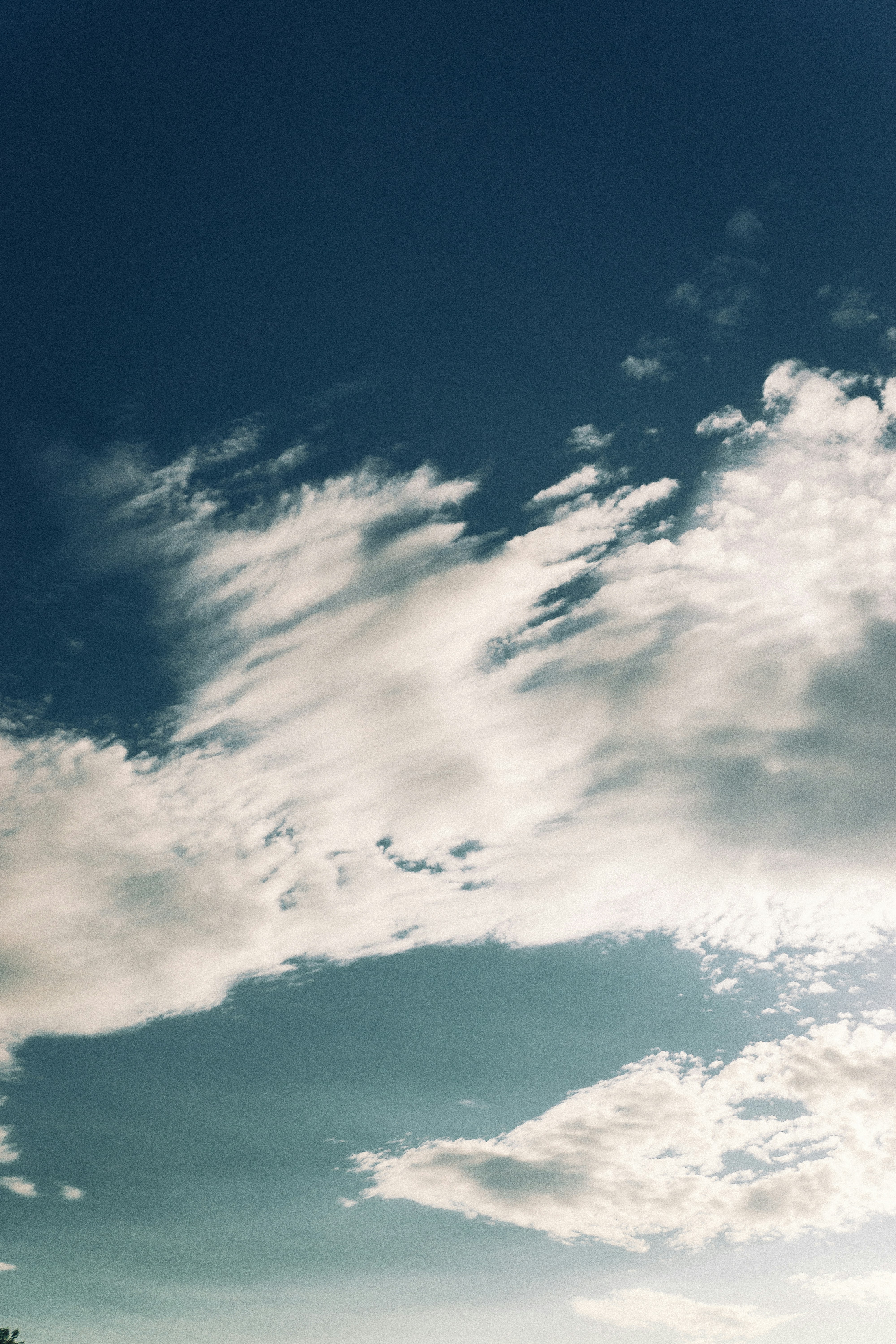 Wispy clouds drift across a deep blue sky.