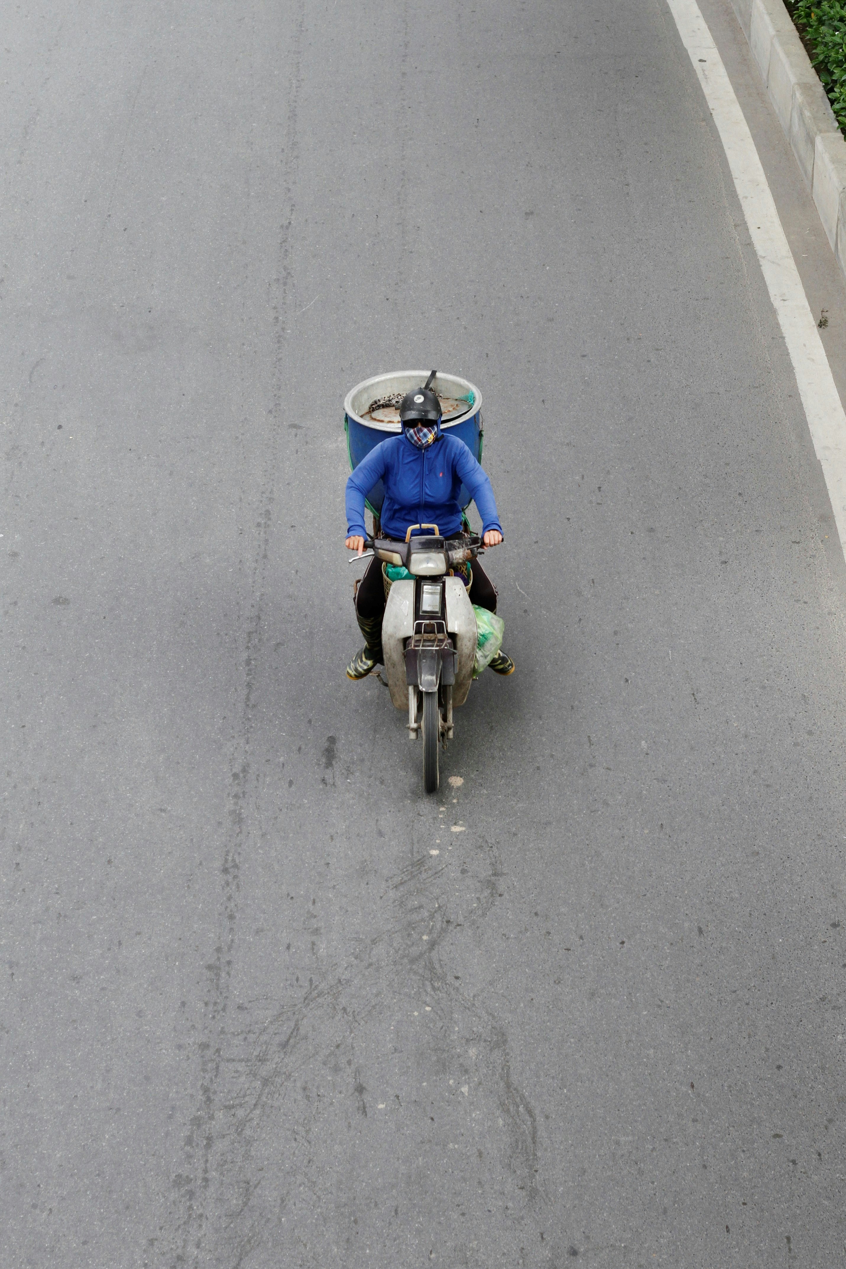 Person riding a scooter on a paved road