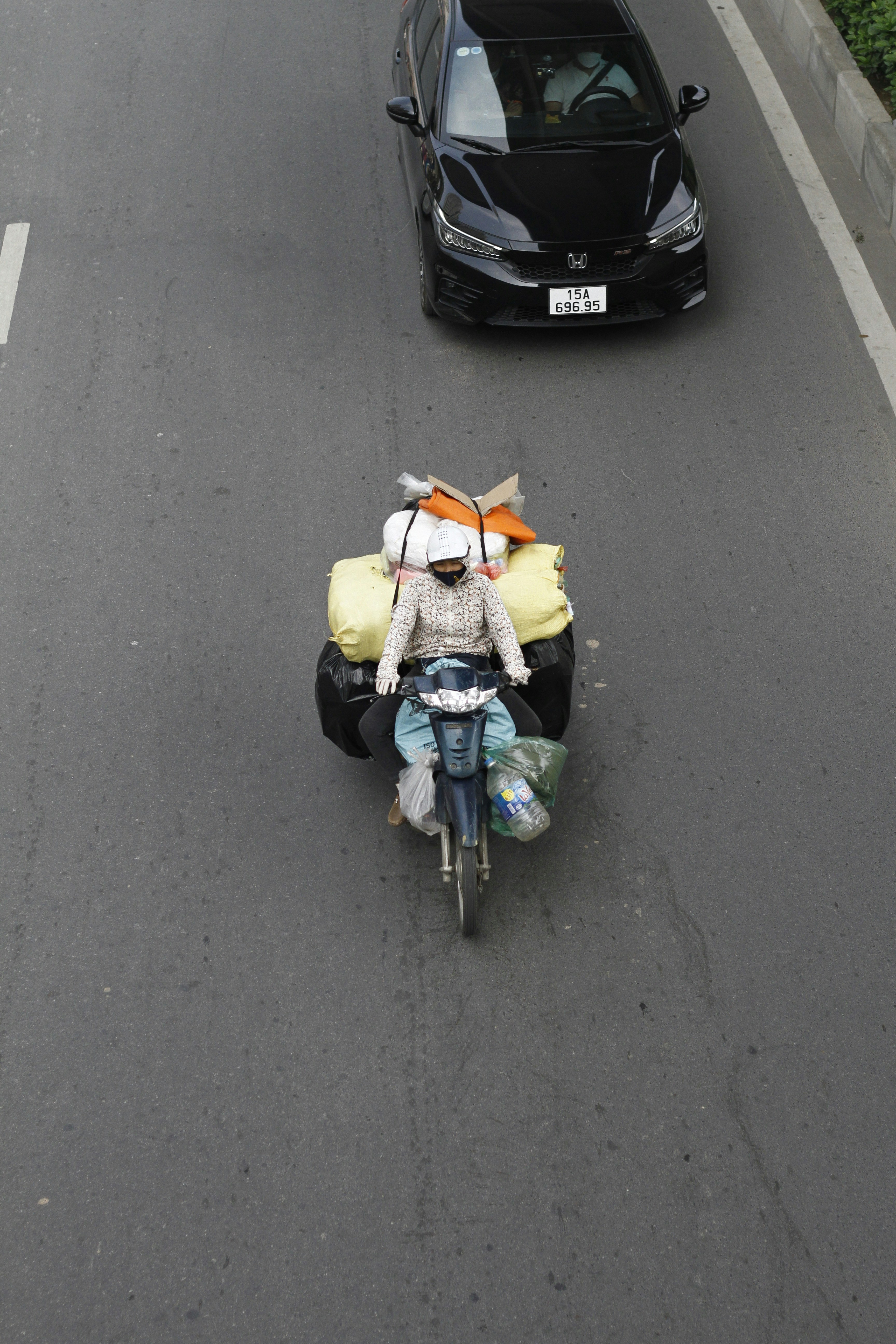 Motorcyclist with large cargo on a city street