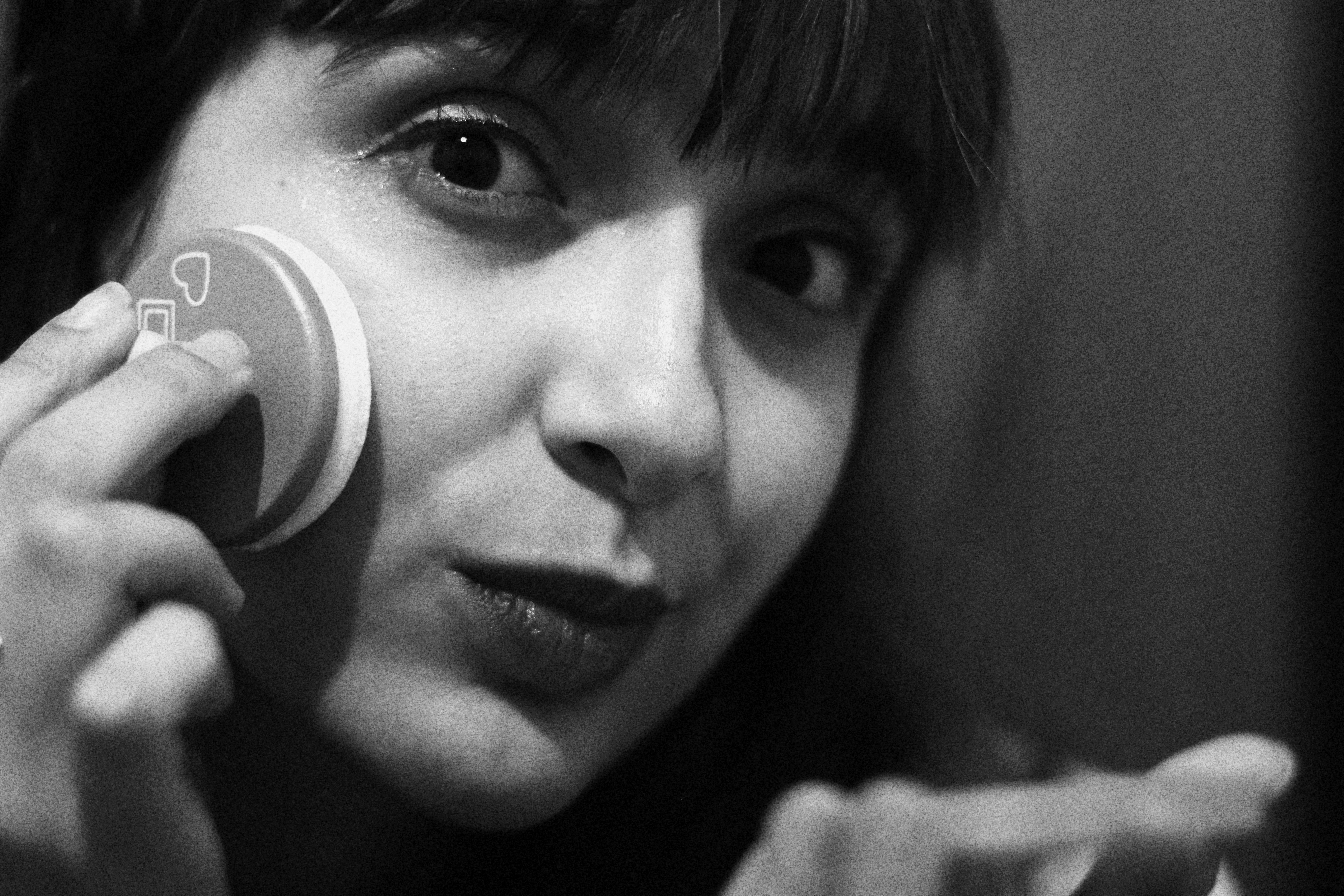 Young woman applying makeup with a powder puff