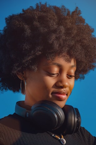 Young woman with headphones around her neck