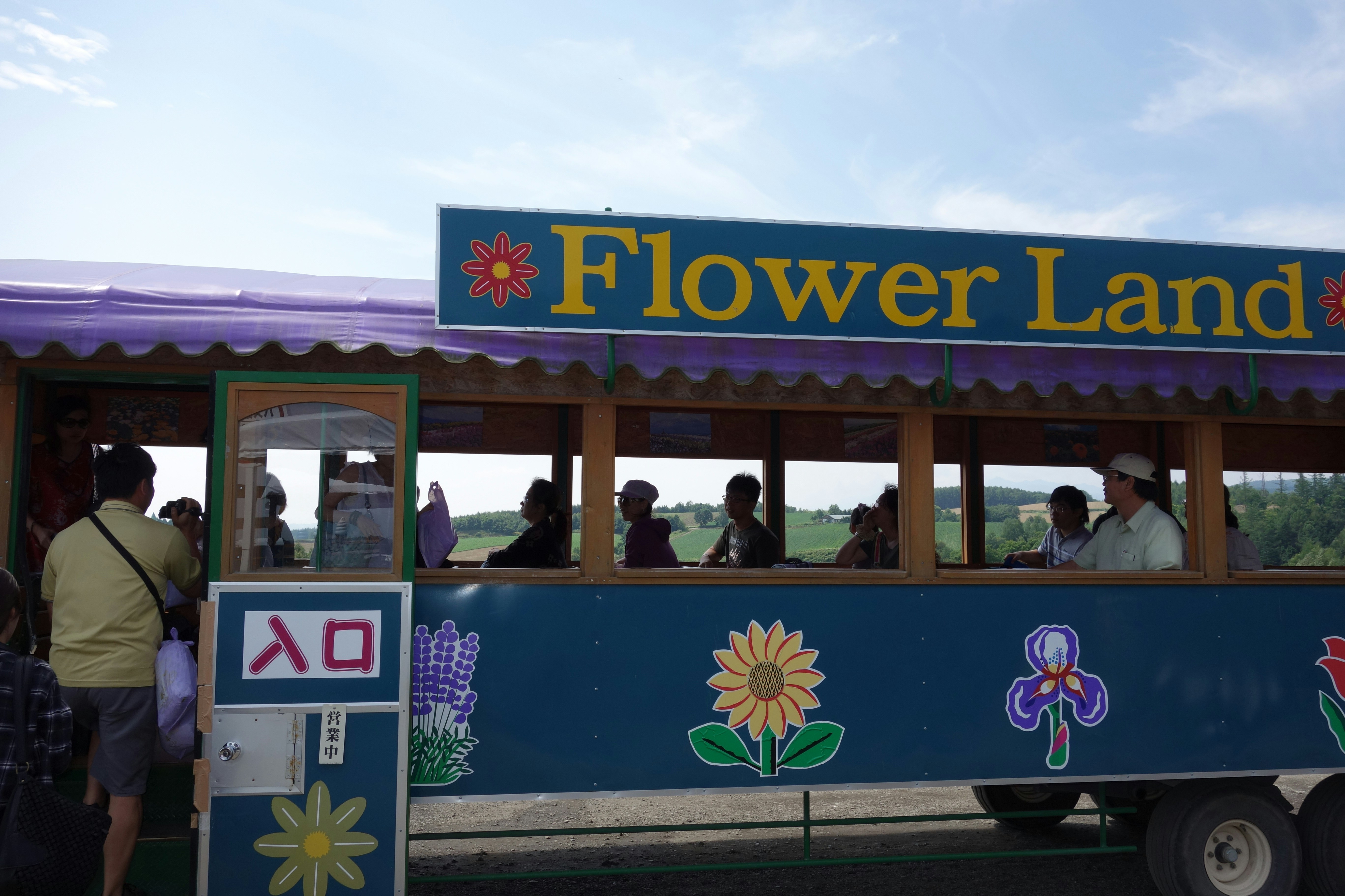People boarding a bus at flower land