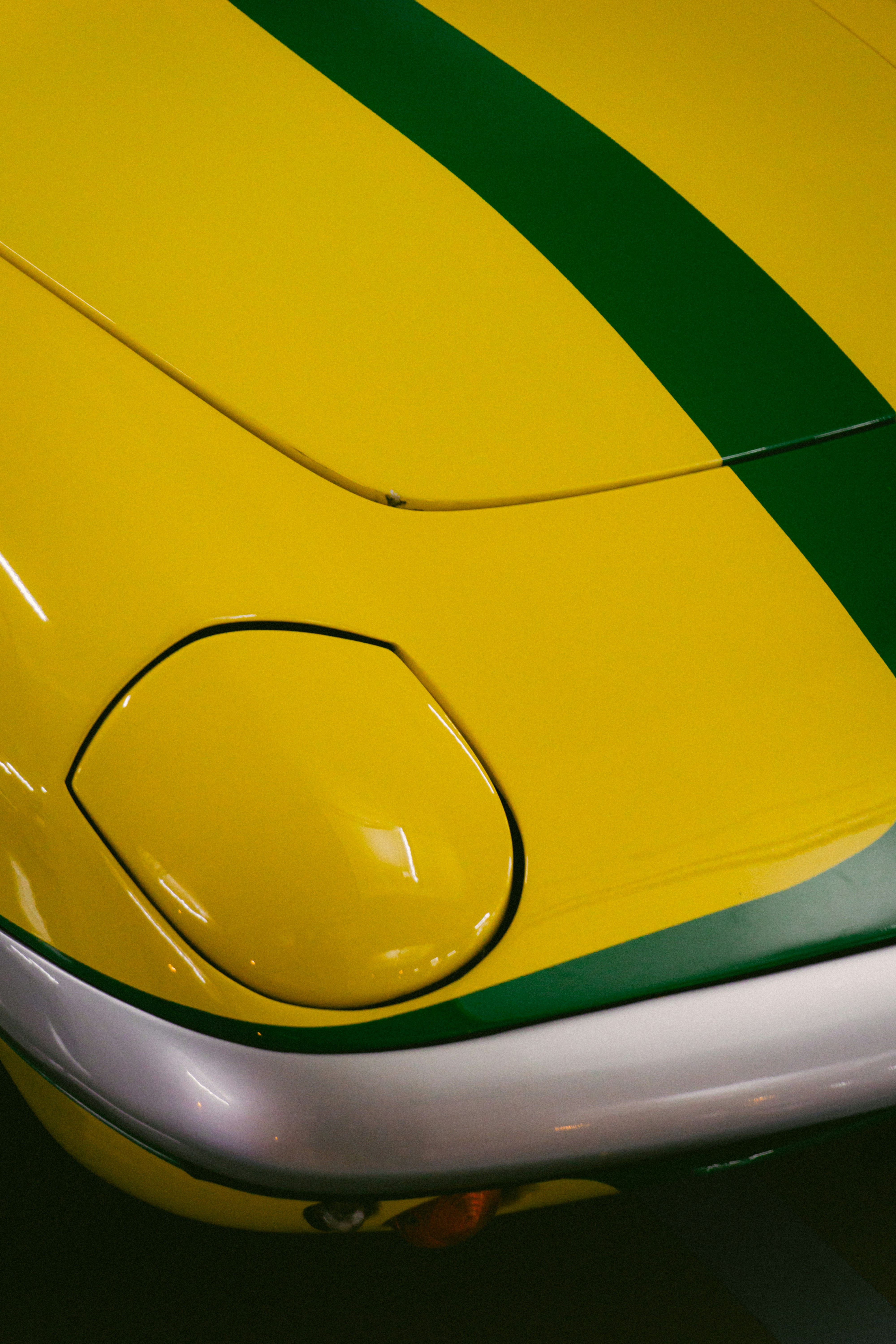 Yellow car with green stripe and headlight detail