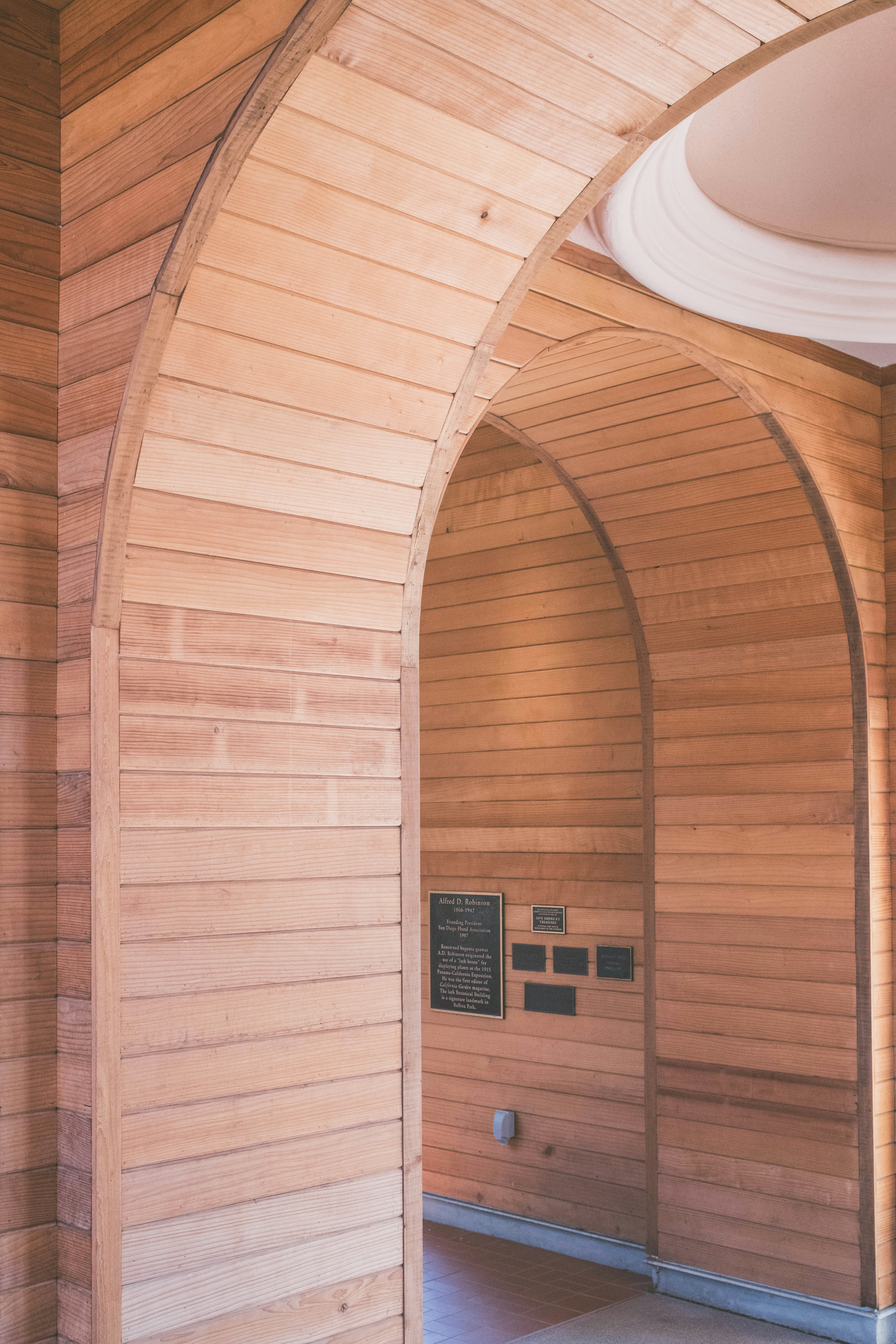 Wooden arched entryway with decorative plaque