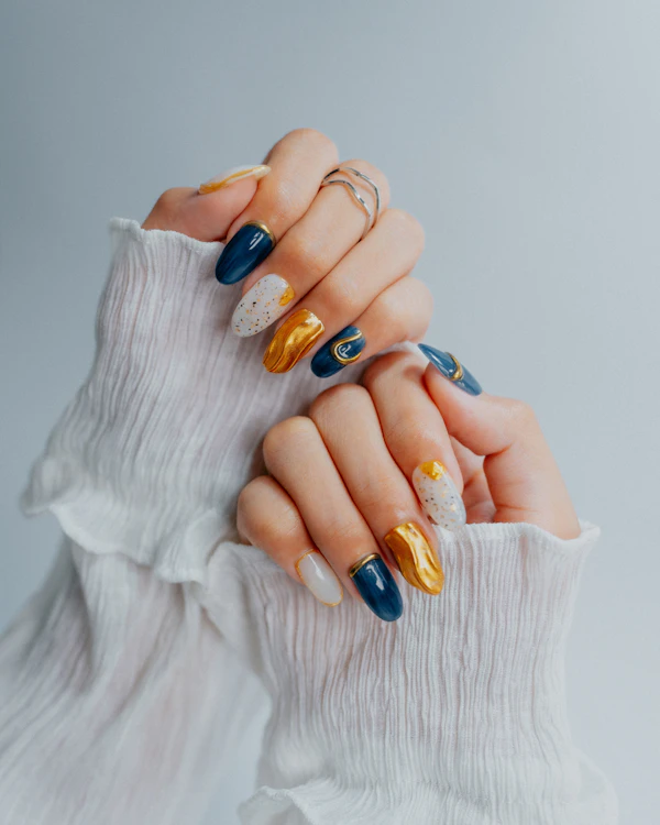 Ornate navy, gold and white nail design
