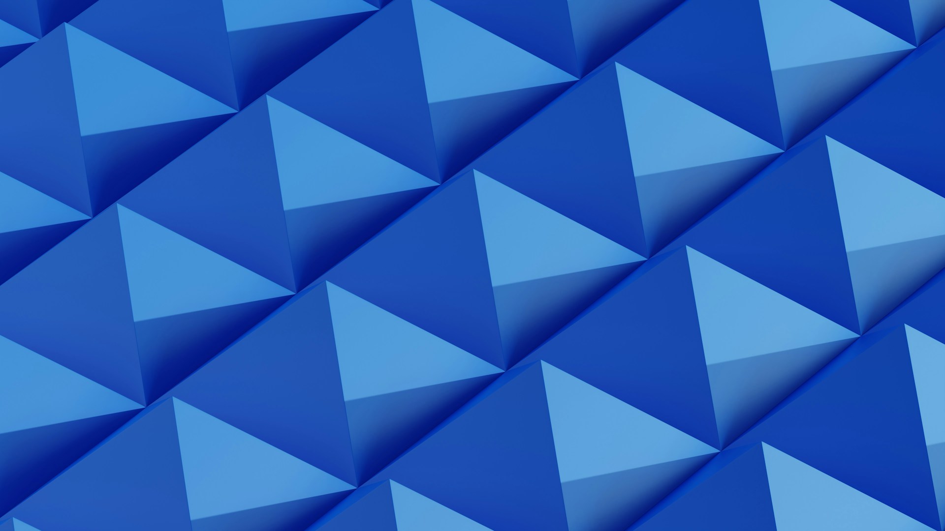 Geometric pattern of blue pyramids in a grid.