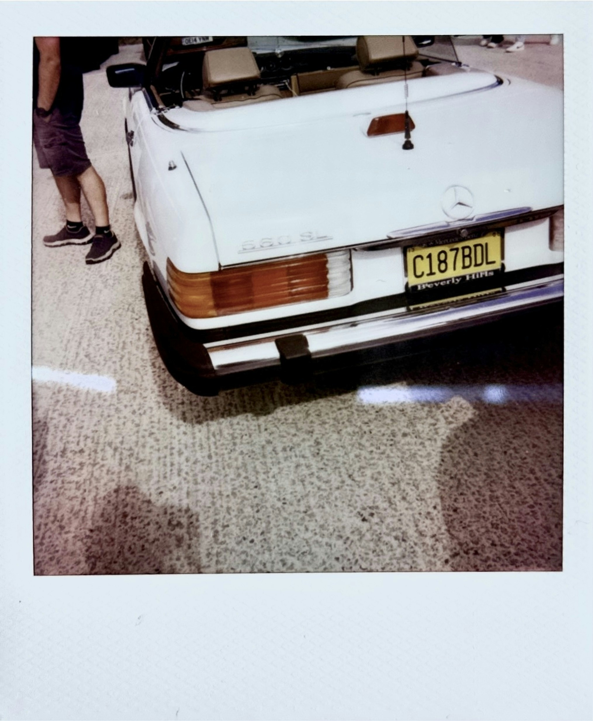 White convertible car parked on a street
