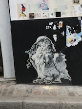 Graffiti of an owl on a black wall