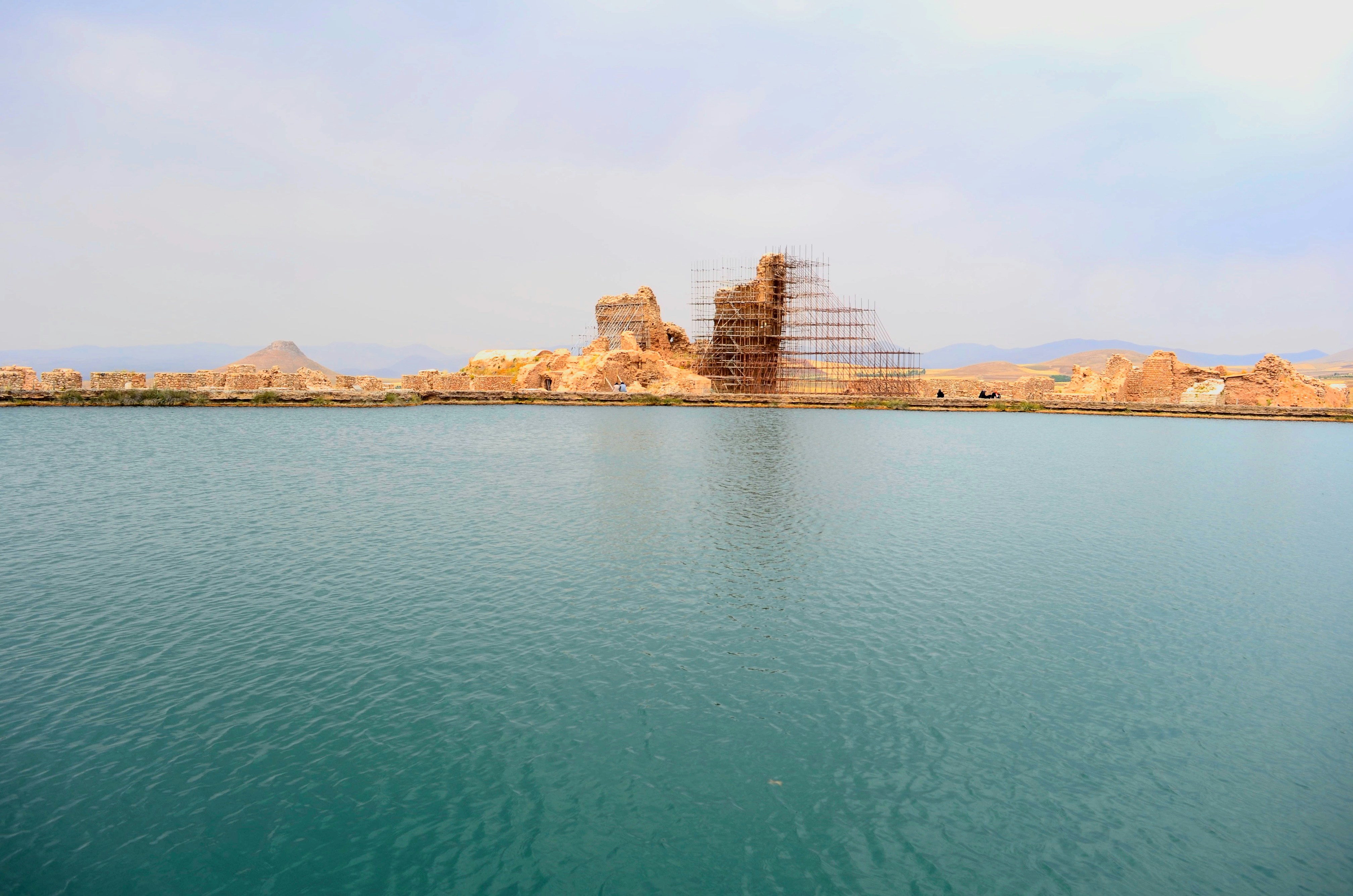 Calm turquoise water with distant city skyline