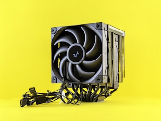 Computer cpu cooler with fan on yellow background