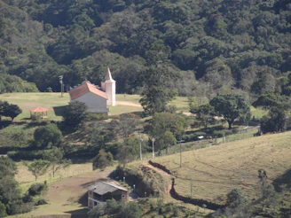 Small church nestled in a lush green valley.