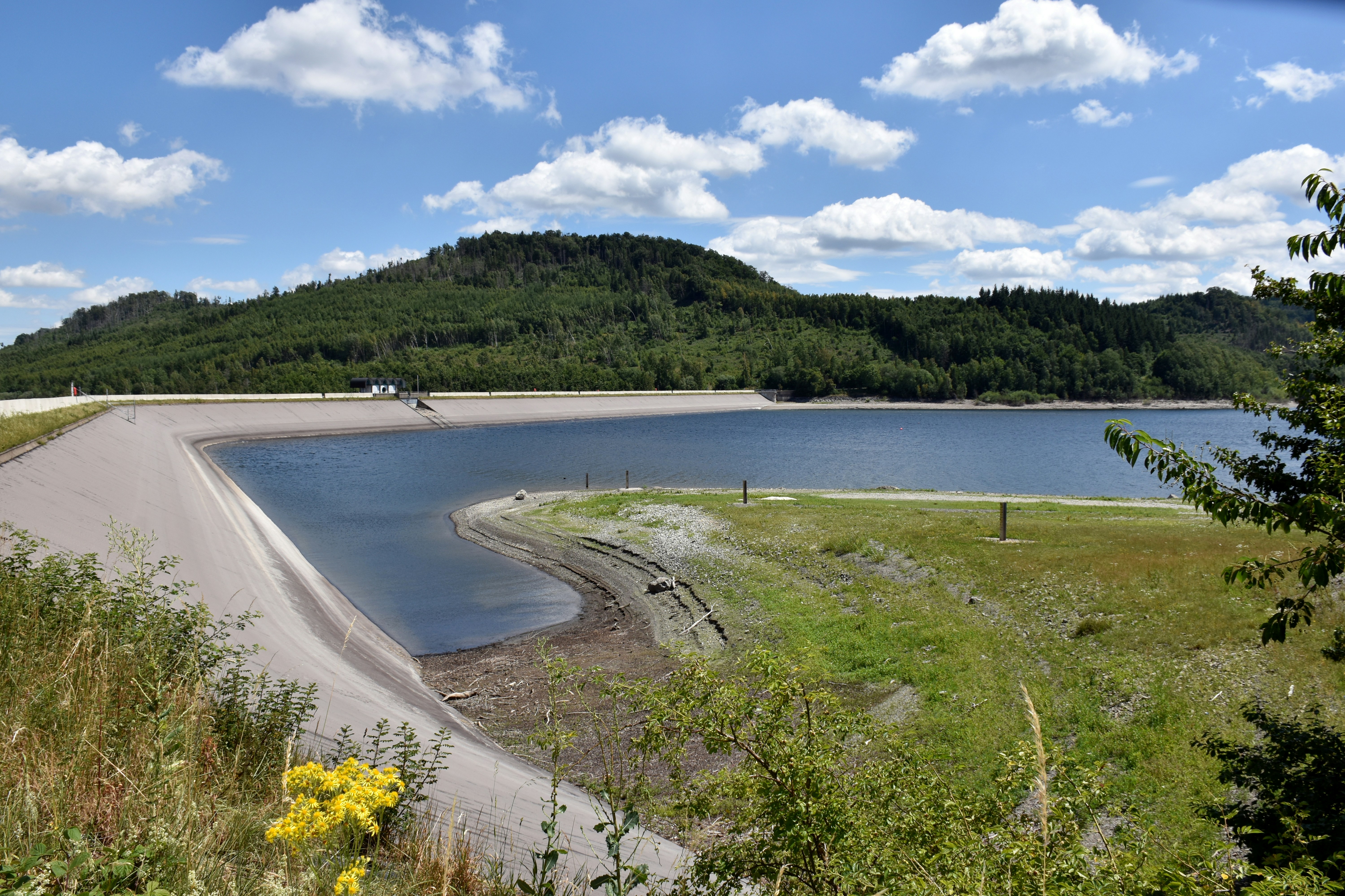 A scenic view of a lake with rolling hills