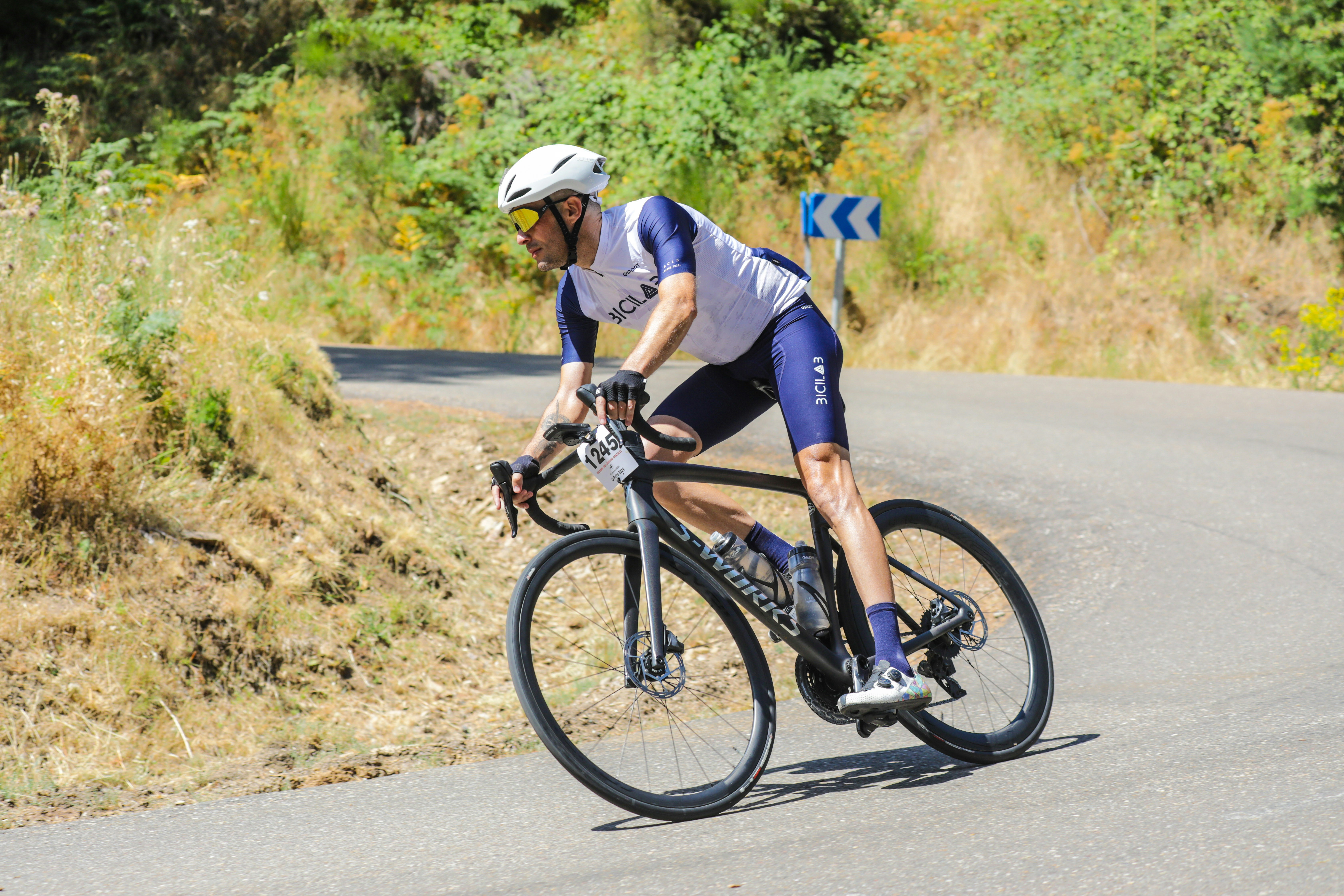 Man cycling uphill on a paved road