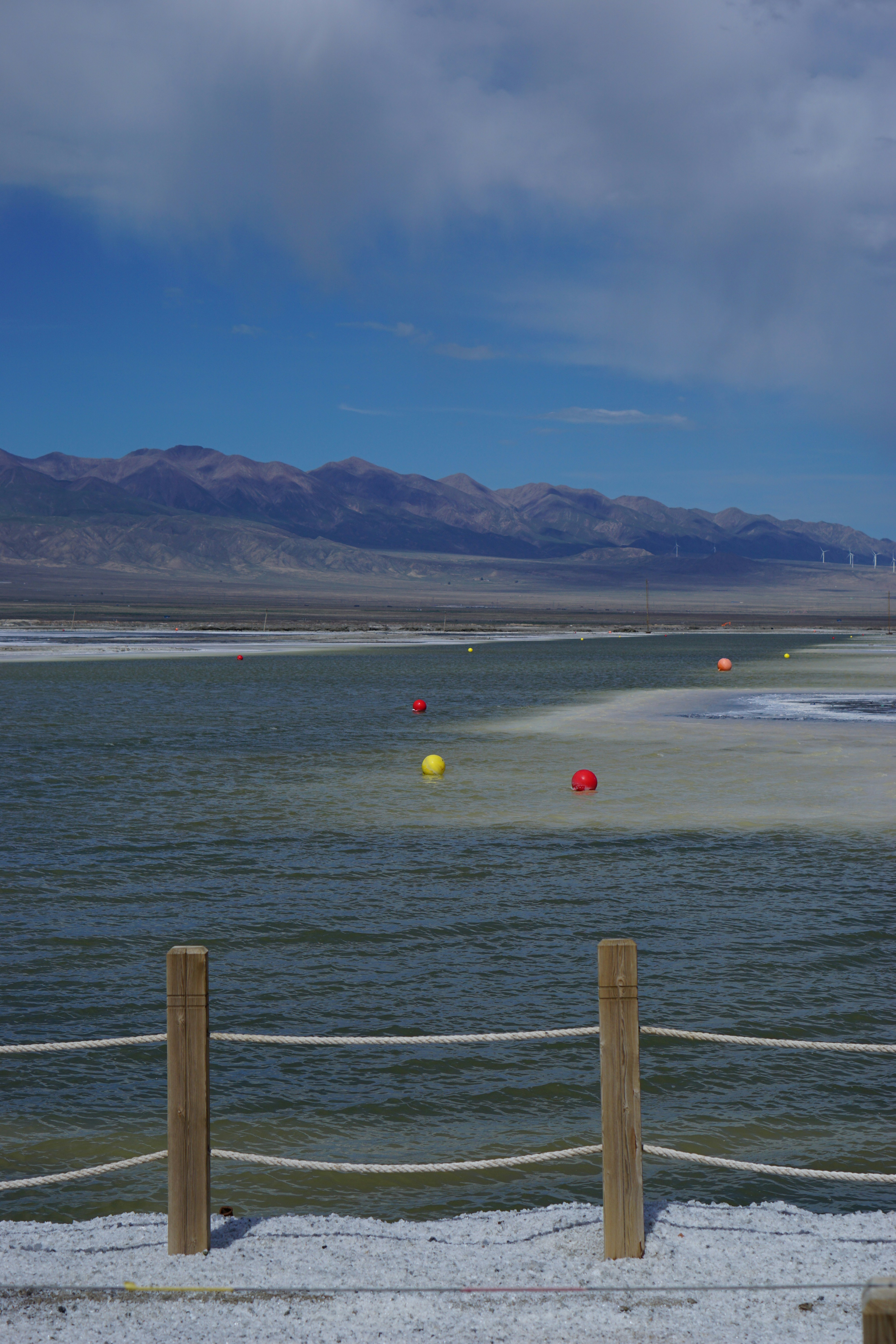 Calm blue water with distant mountains under sky